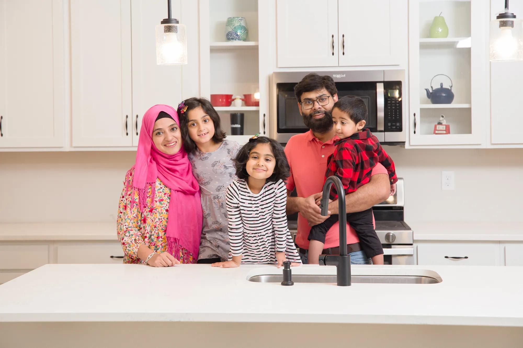New homeowners standing around in the Alwick kitchen