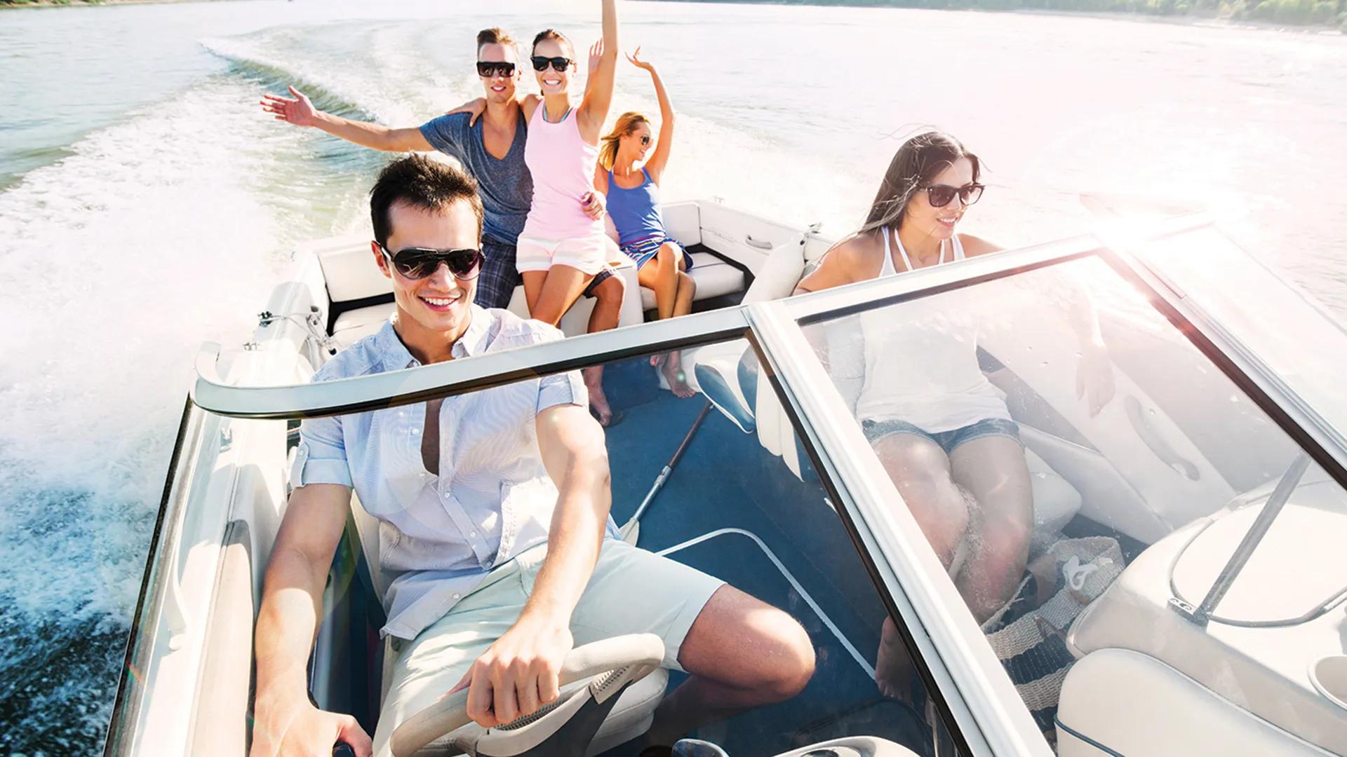 group relaxing and driving boat