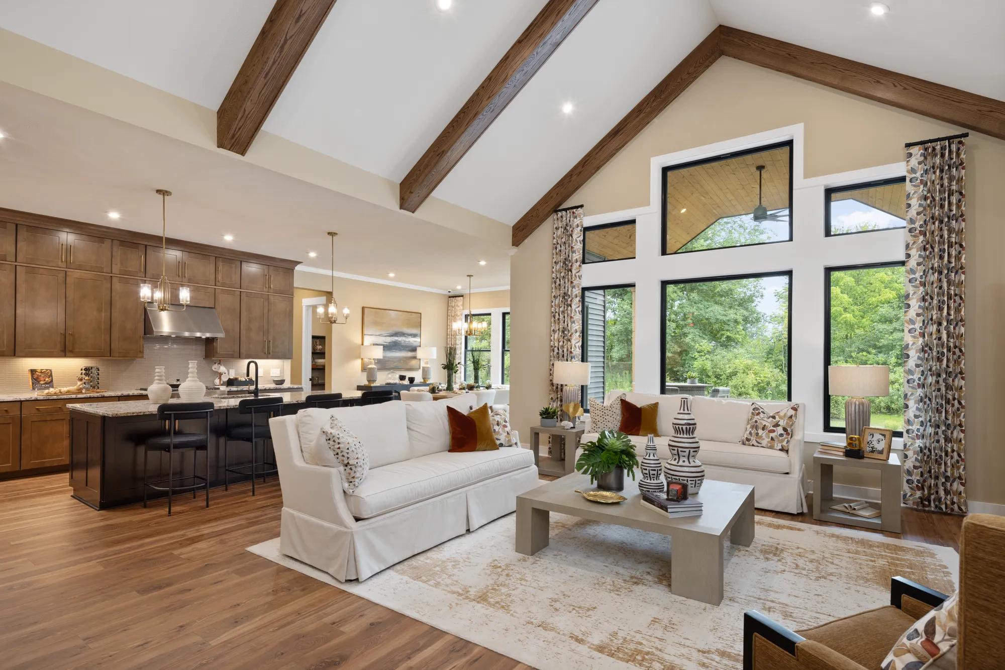 Custom home open floor plan family room with vaulted wood beam ceiling