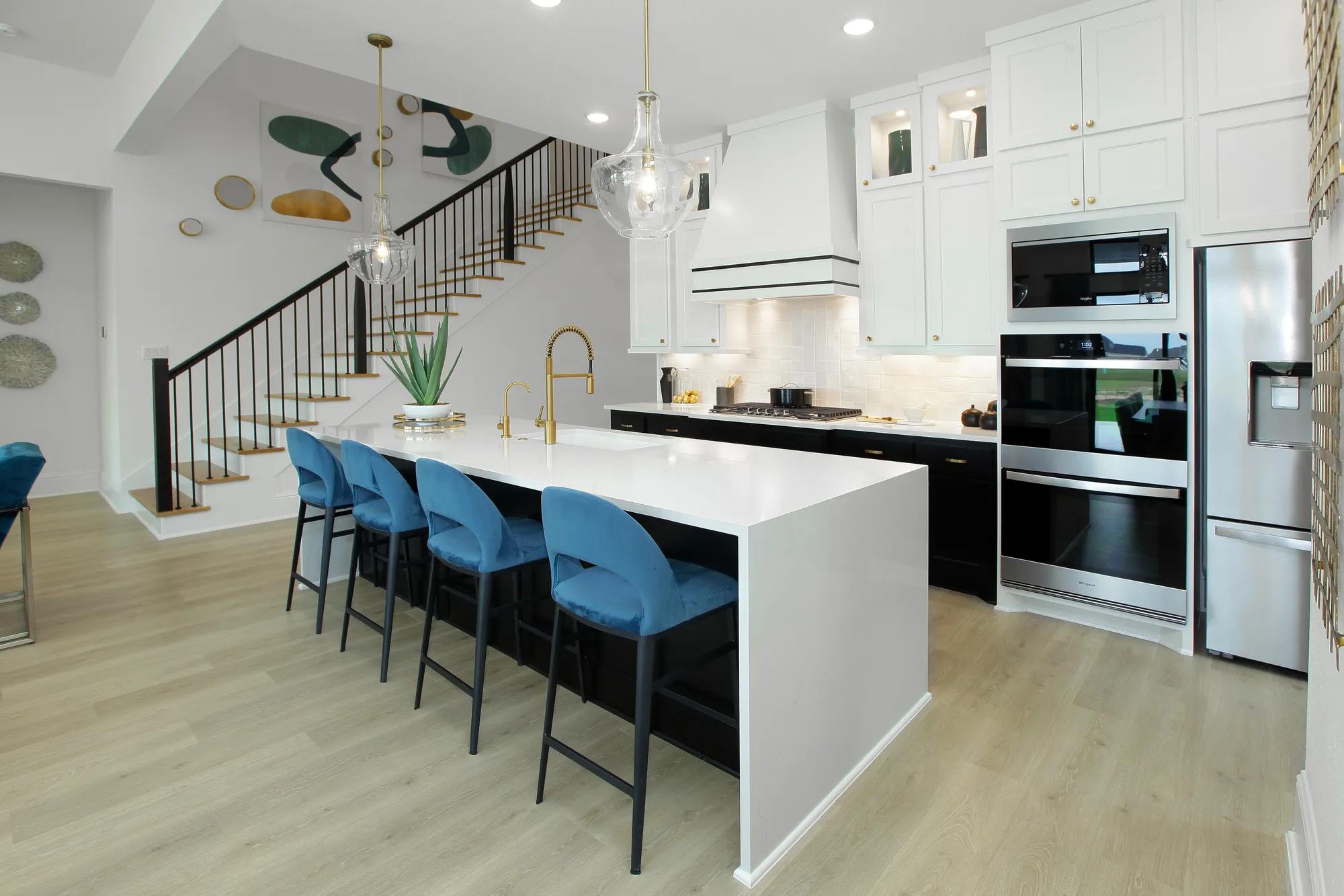 Custom home kitchen with double ovens and stainless steel appliances 