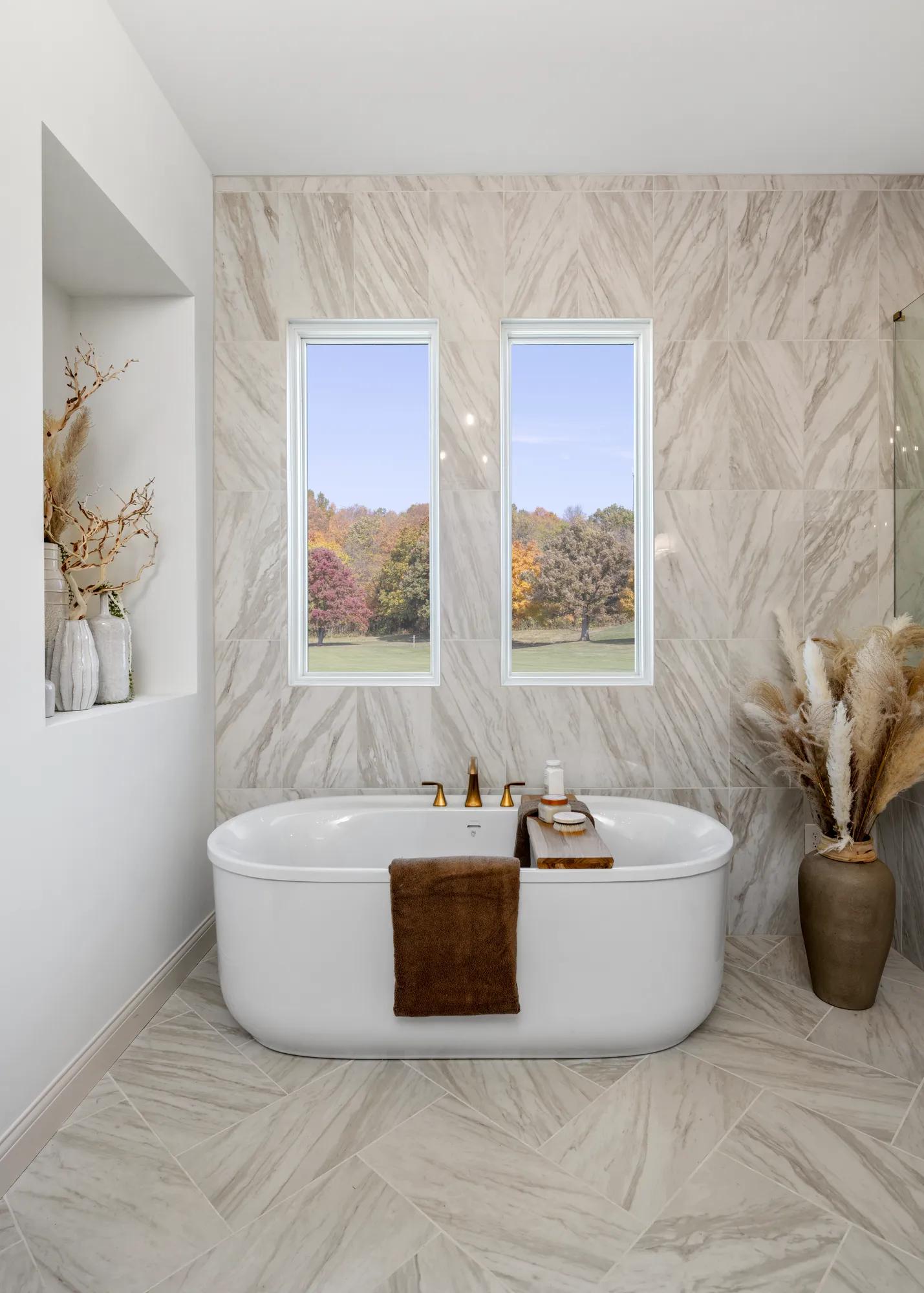 new home primary bath with freestanding tub