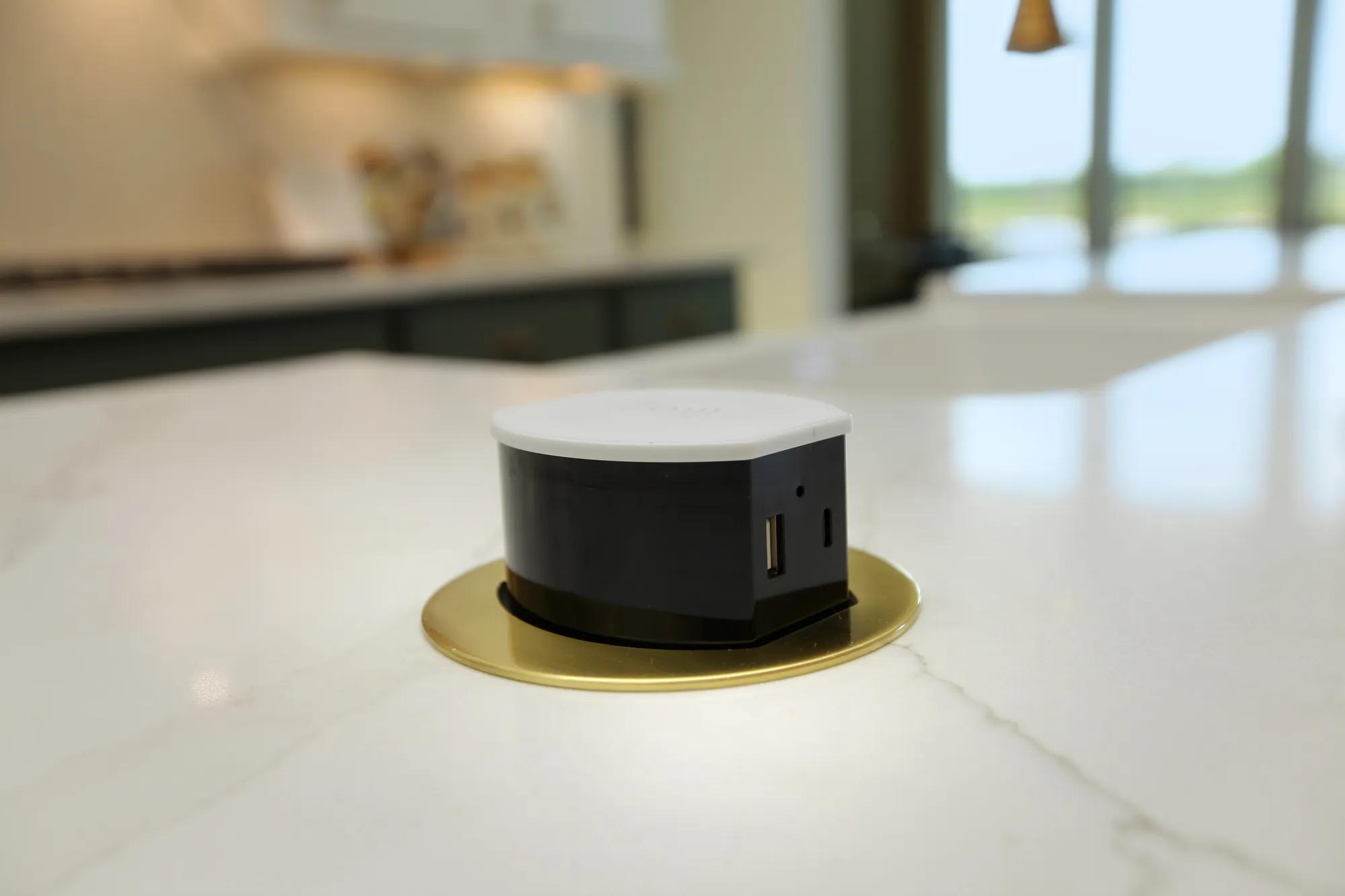 Custom home pop up outlet built into kitchen countertop