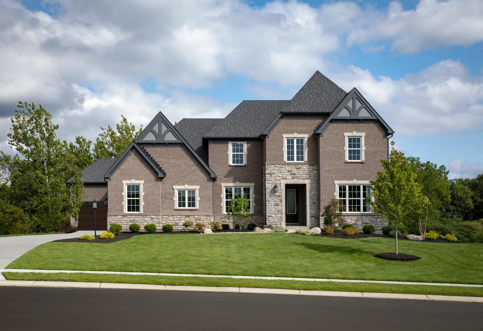custom two-story home with stone and brick