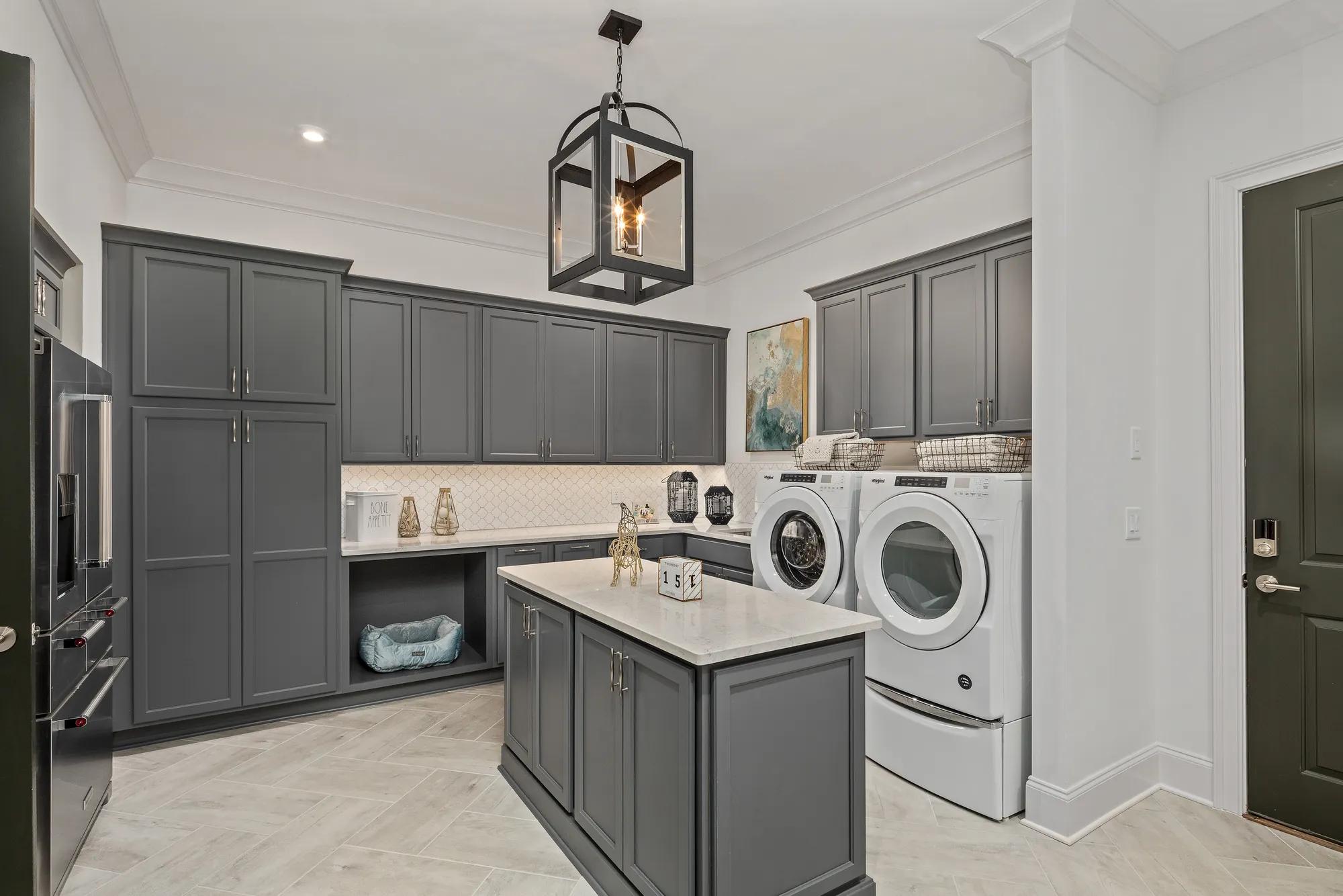 laundry room with gray cabinets and island