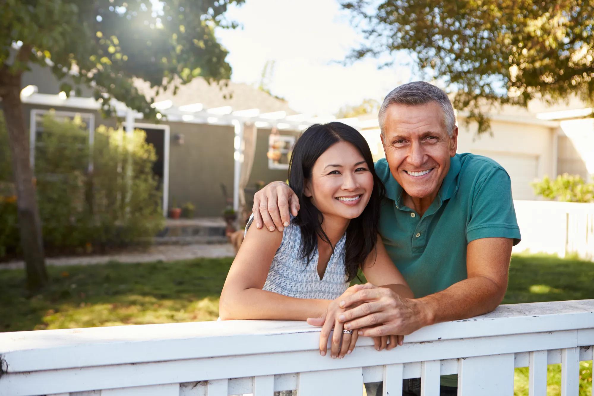 Couple in front of home