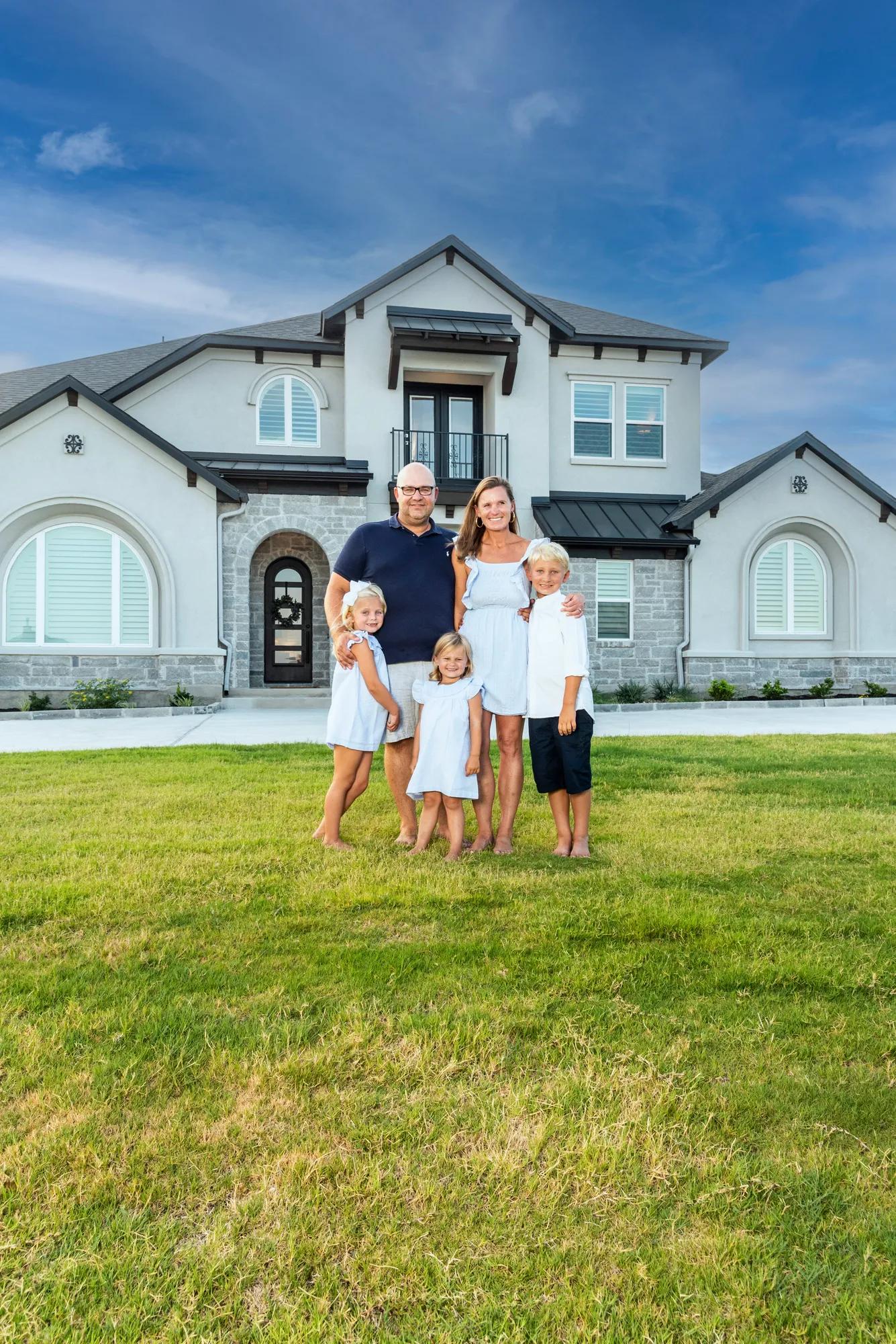 New homeowners outside of their Drees Home exterior