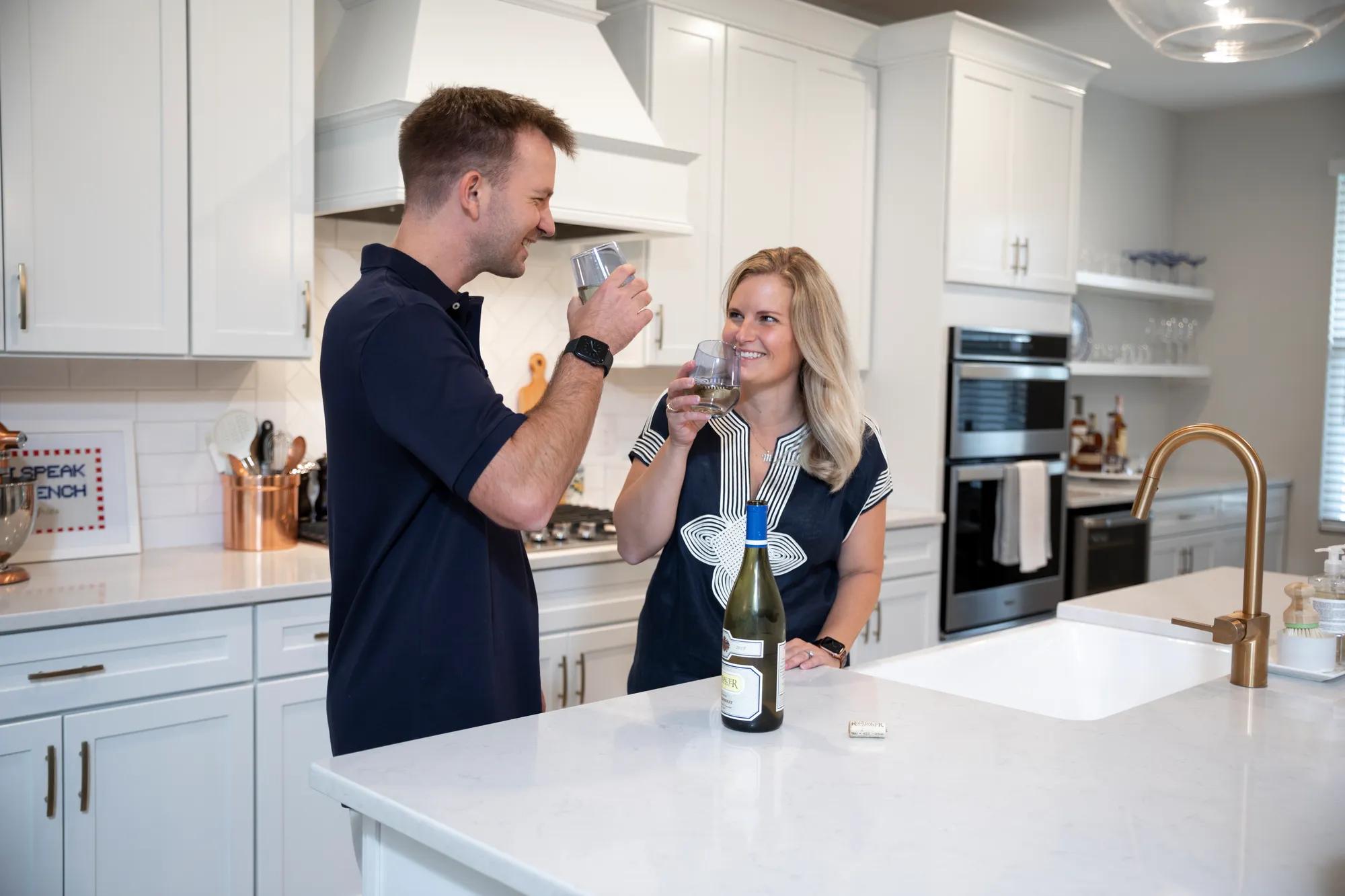 New Drees homeowners enjoying a relaxing night in their new Drees home kitchen
