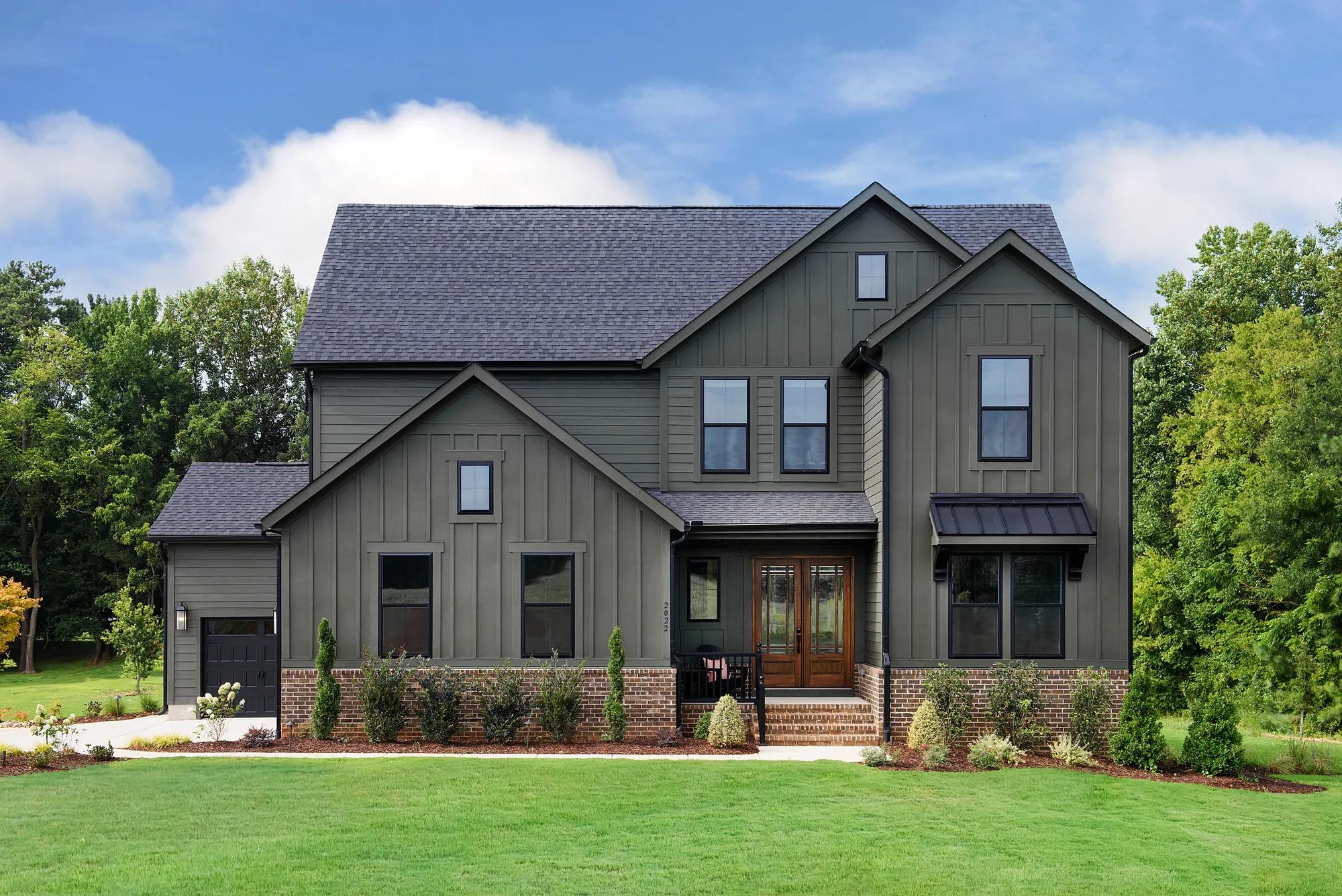 Dark green custom home with black accents