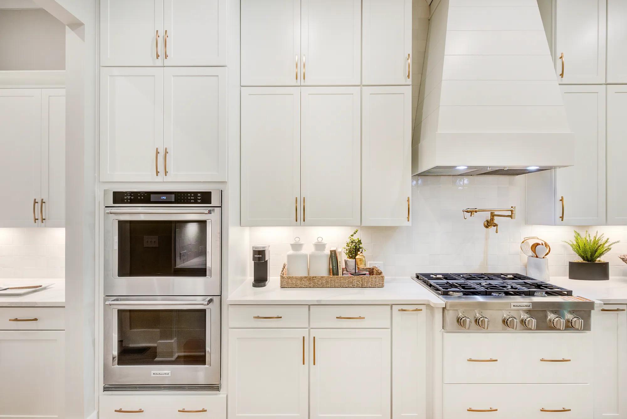 New home kitchen with double ovens and gas cooktop stainless steel appliances 