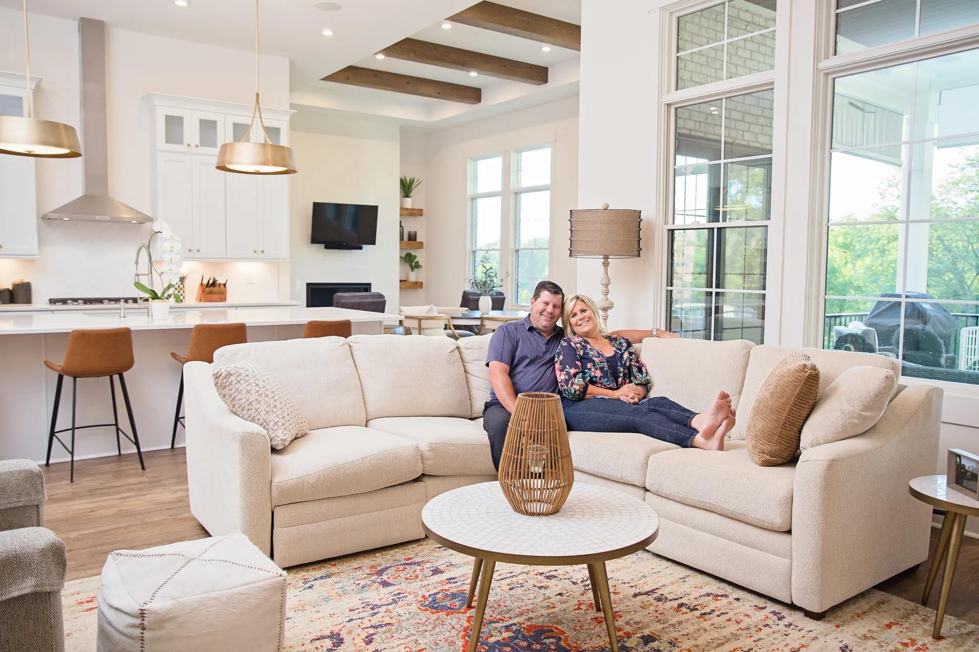 New homeowners enjoying their luxurious living room with a bright and spacious interior