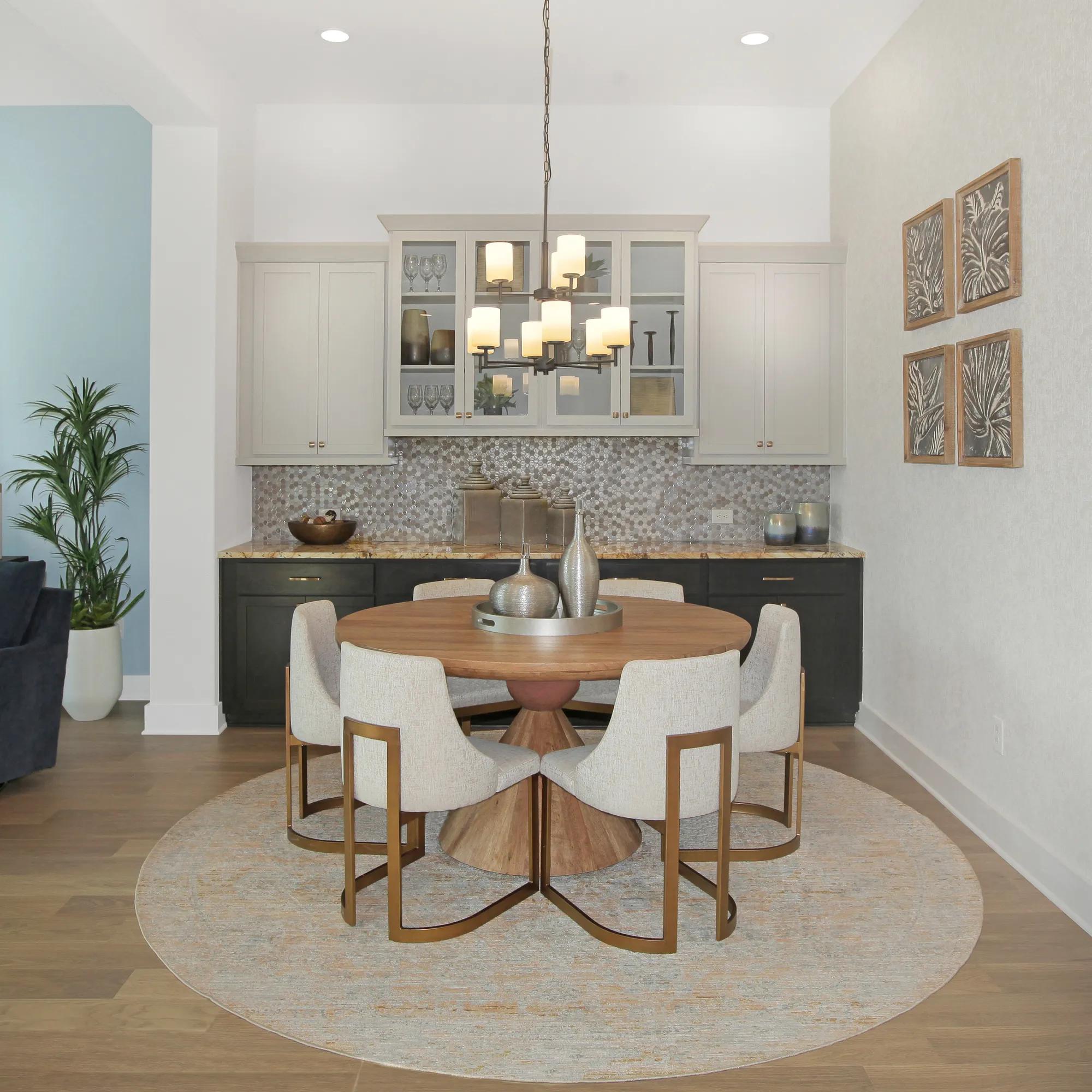 Contemporary dining room with designer chandelier and built-in cabinetry