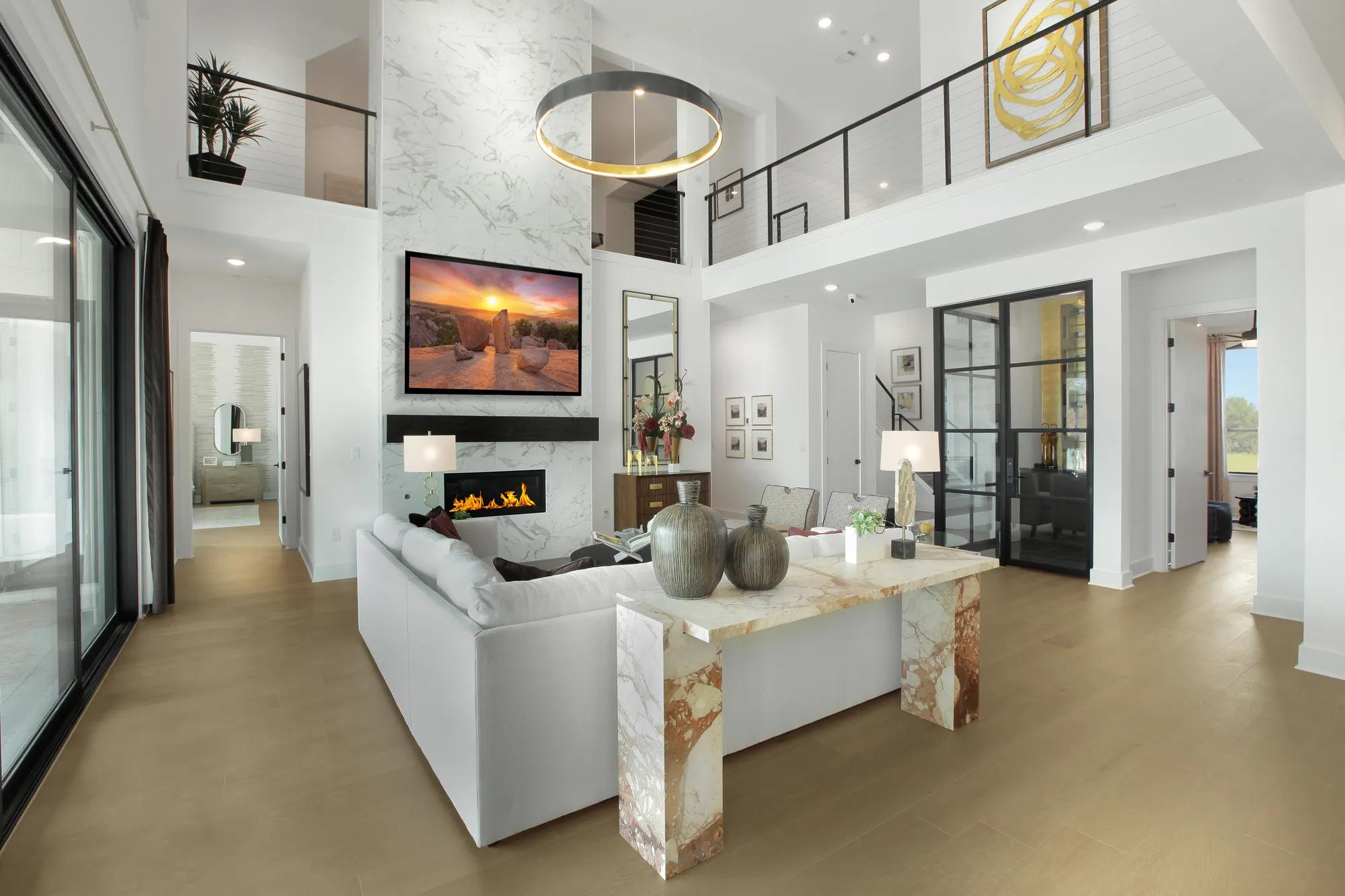 Custom home two-story family room with tile fireplace and glass wine room