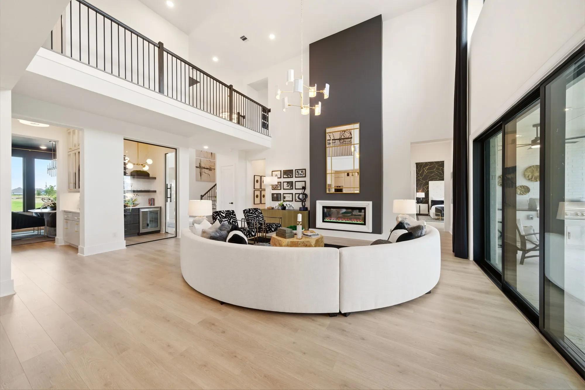 Custom home open floor plan two-story family room with fireplace, wine room, and butler's pantry