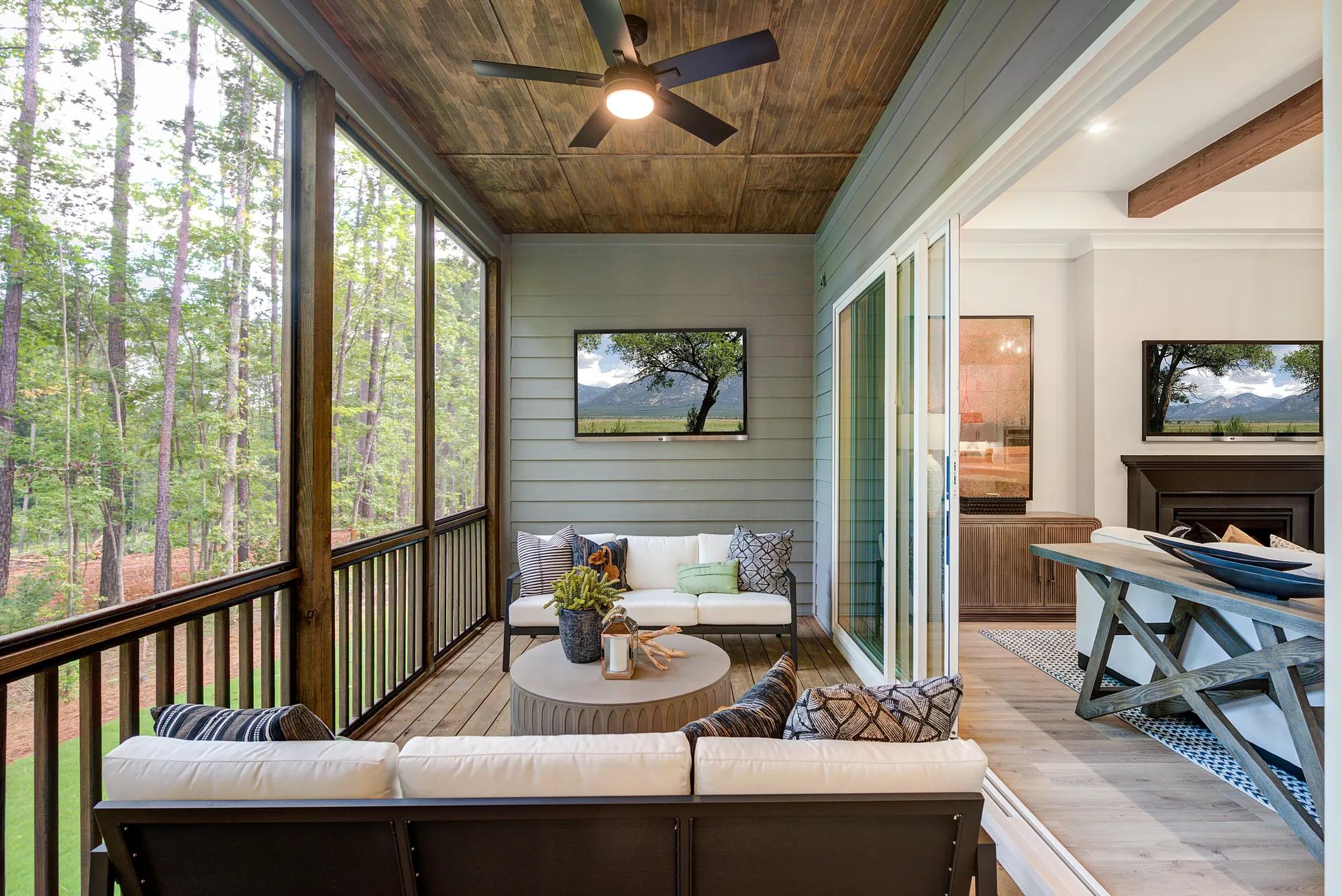 Sliding glass doors to new home covered porch with wood accents