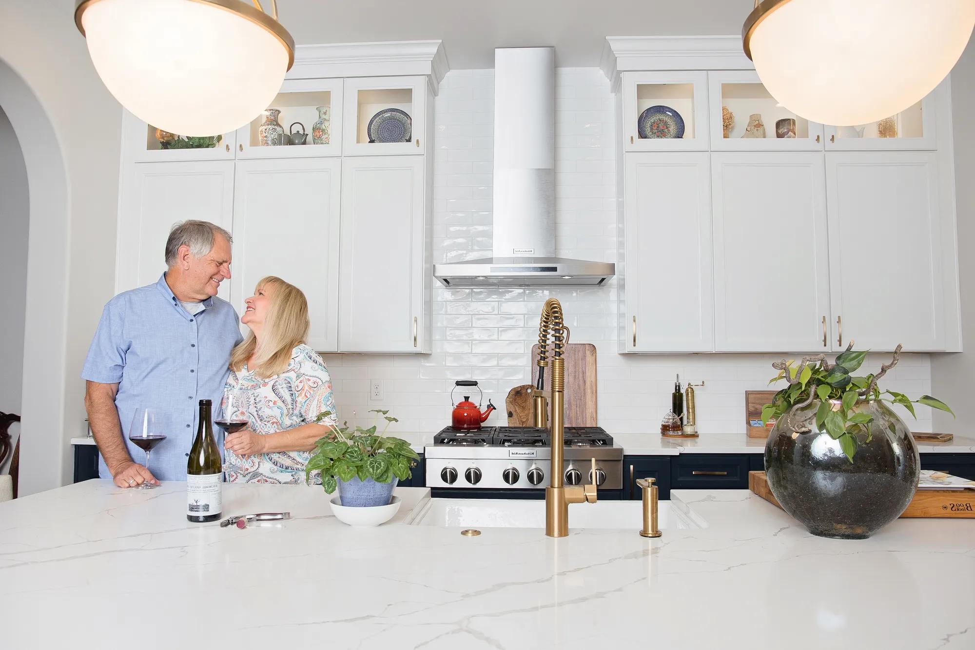 Couple enjoying wine in new home kitchen