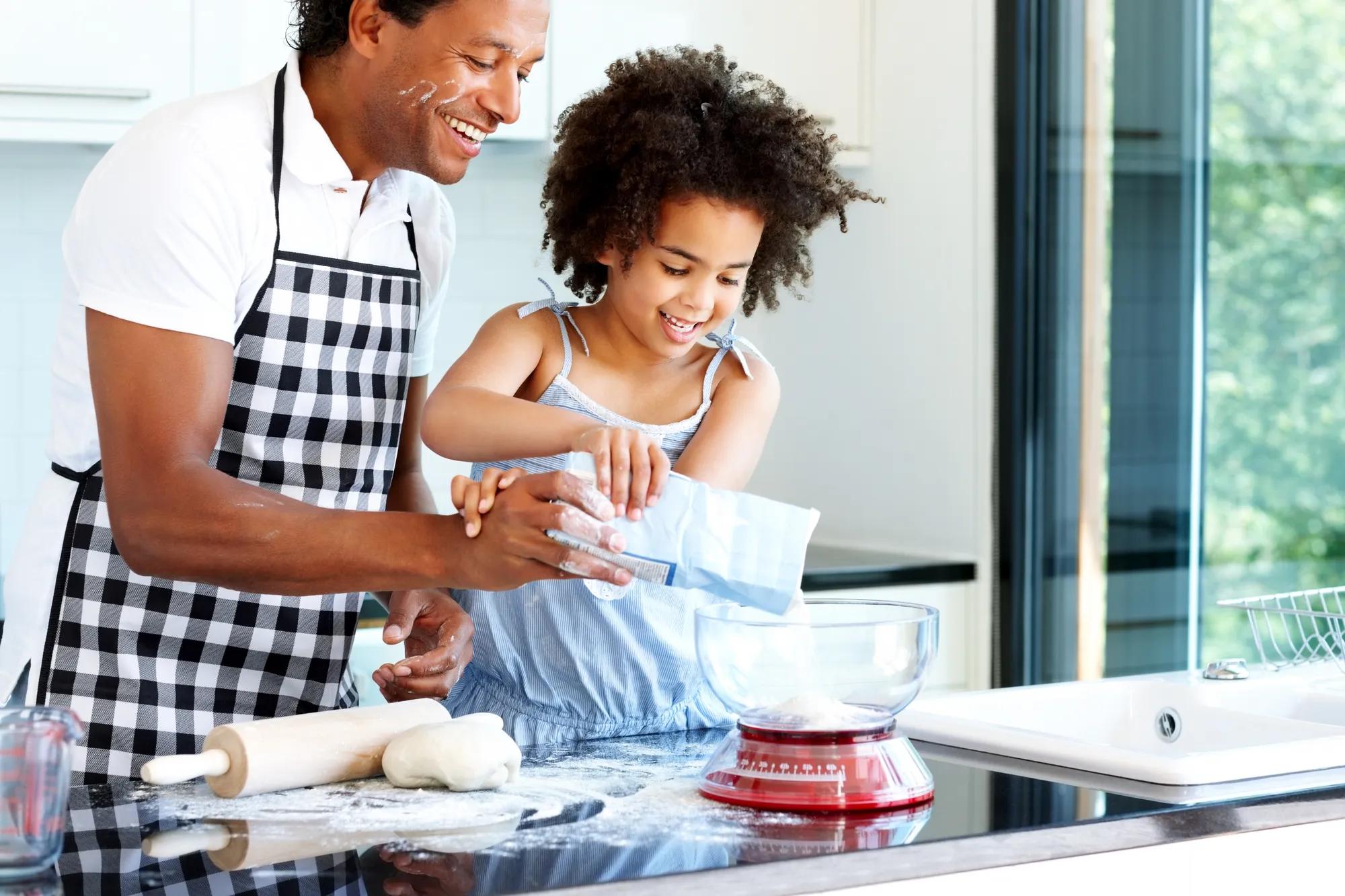 Father daughter baking in new home kitchen