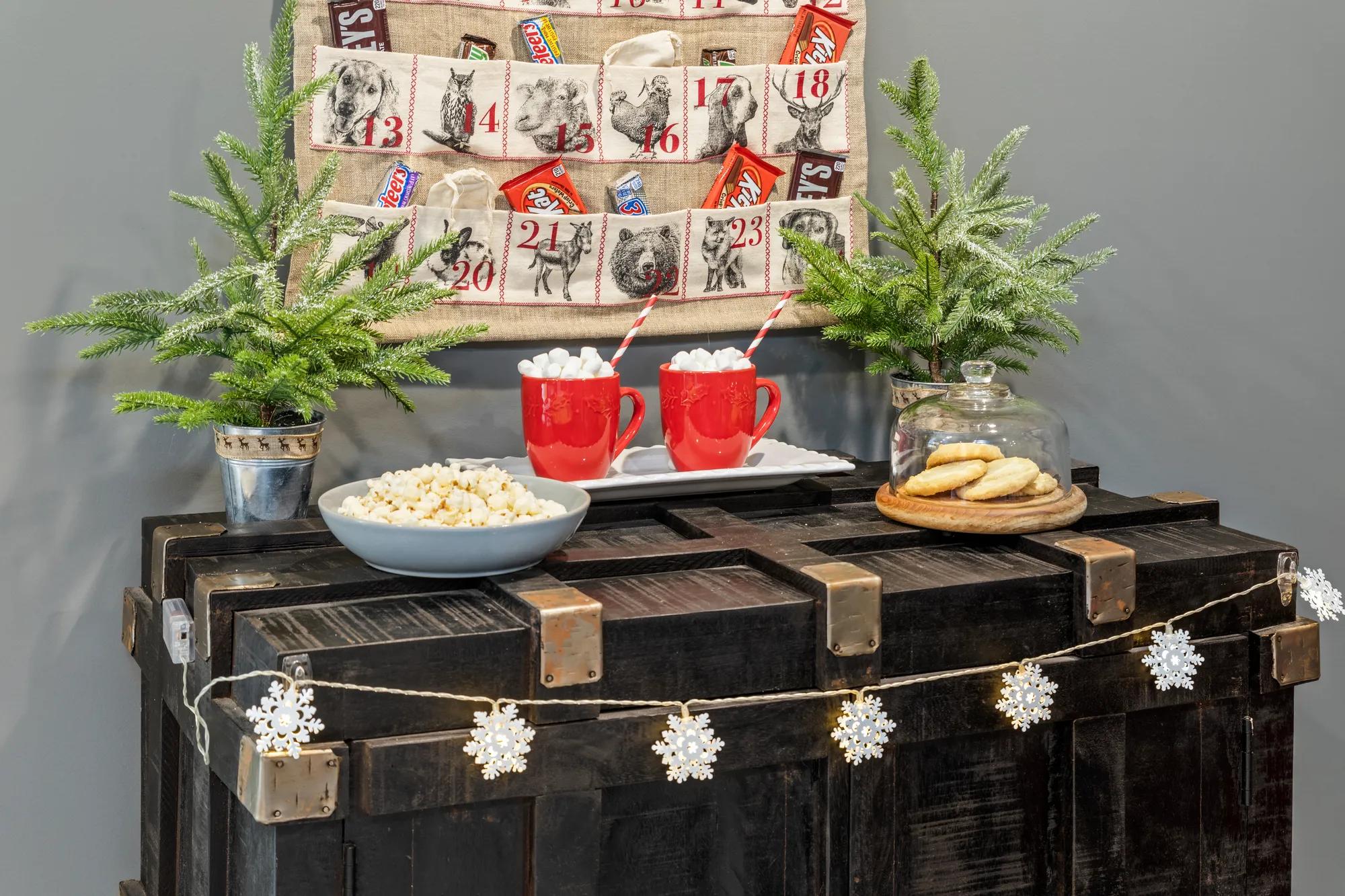 A beautiful holiday calendar and hot chocolate cups presented in a new home