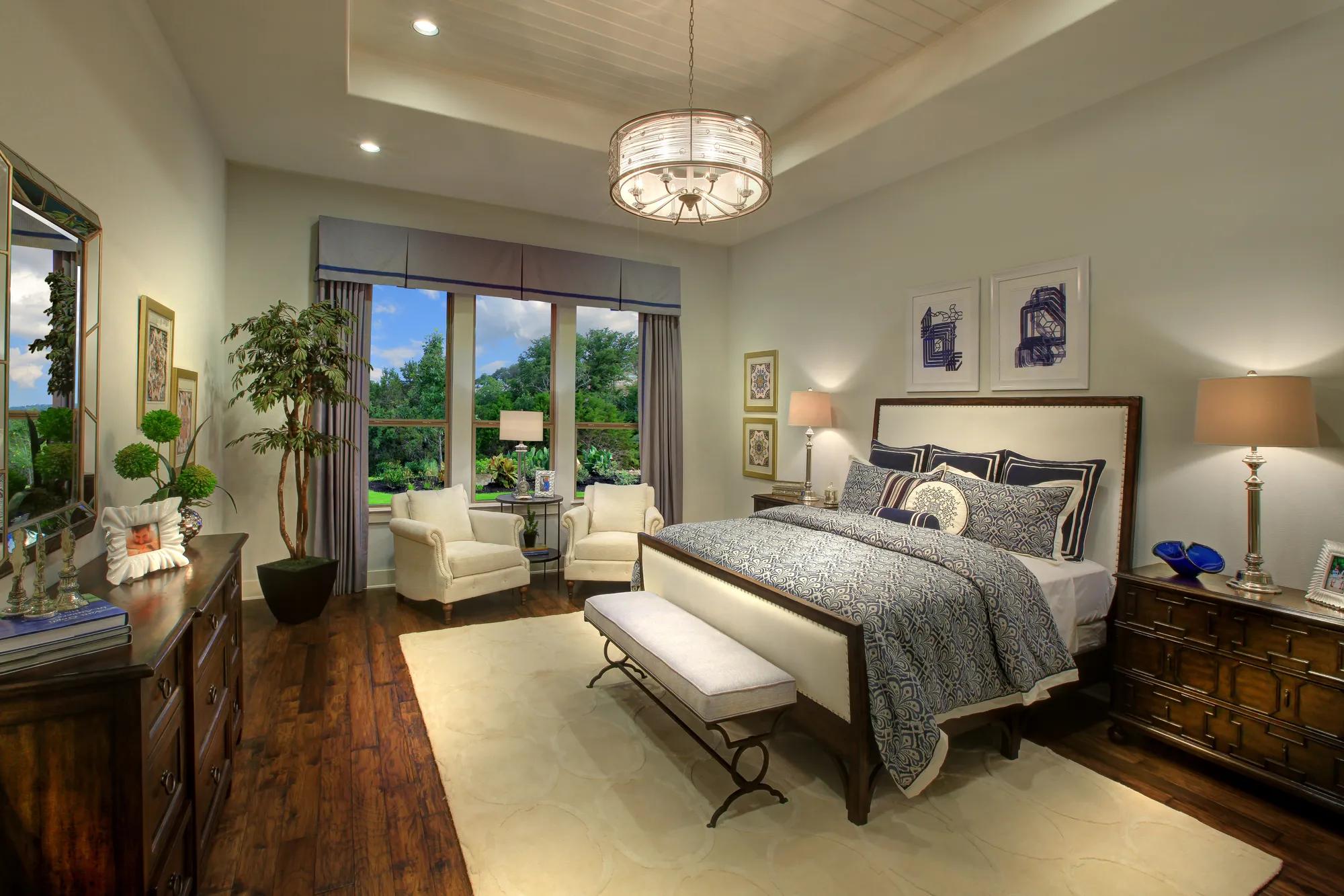 Owner's bedroom with a tray ceiling featuring shiplap