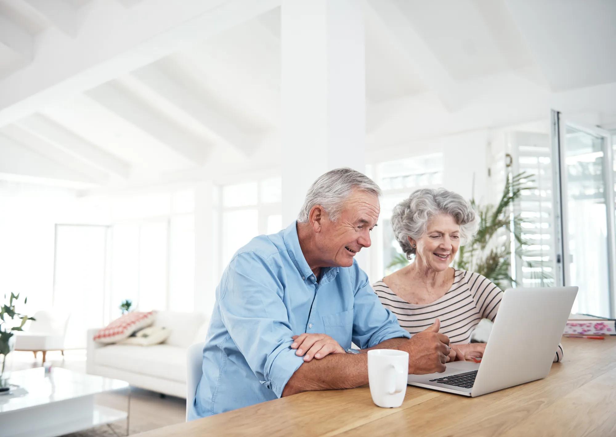 Couple using laptop at home