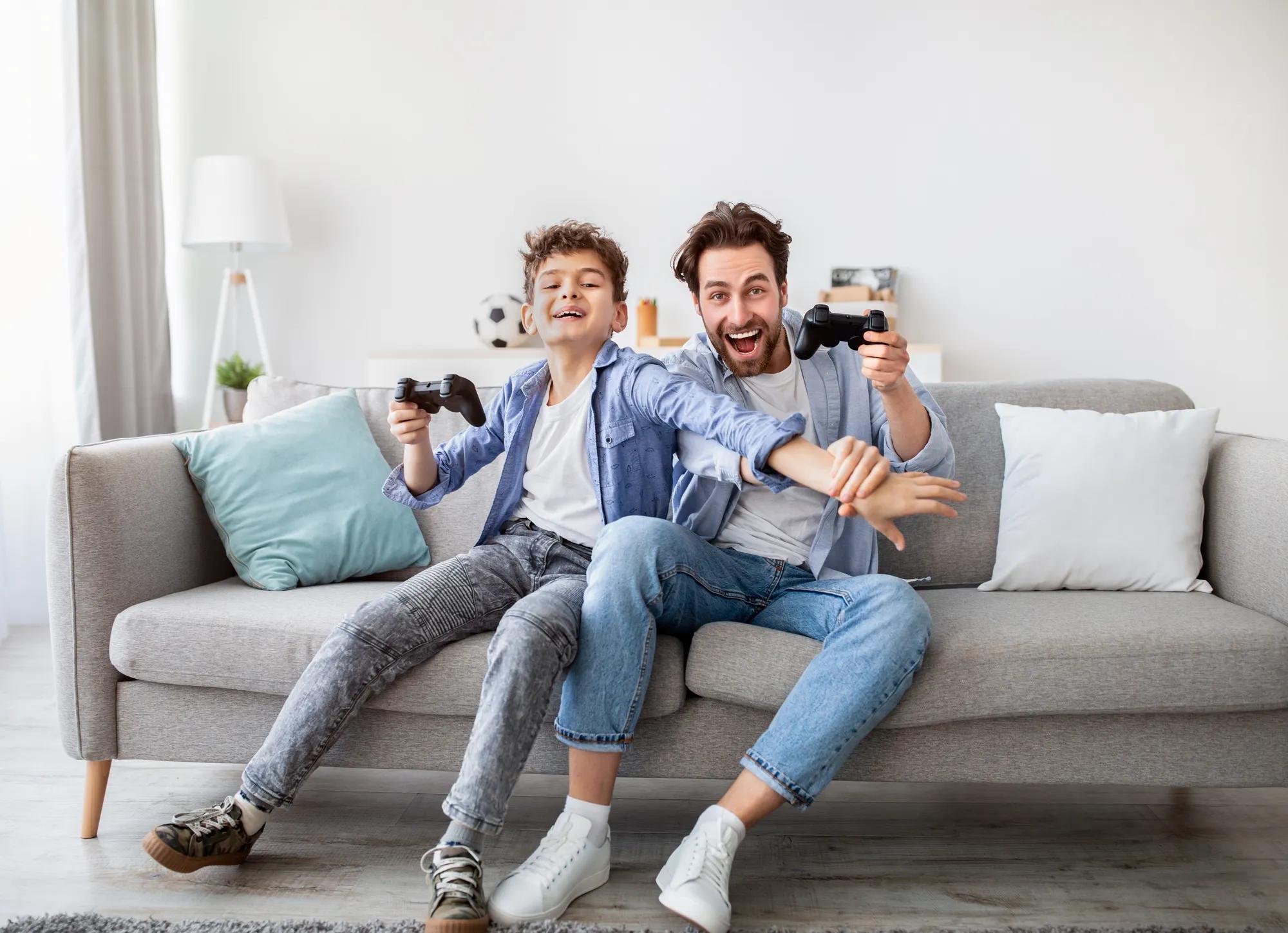 Father son playing video games in new home gameroom