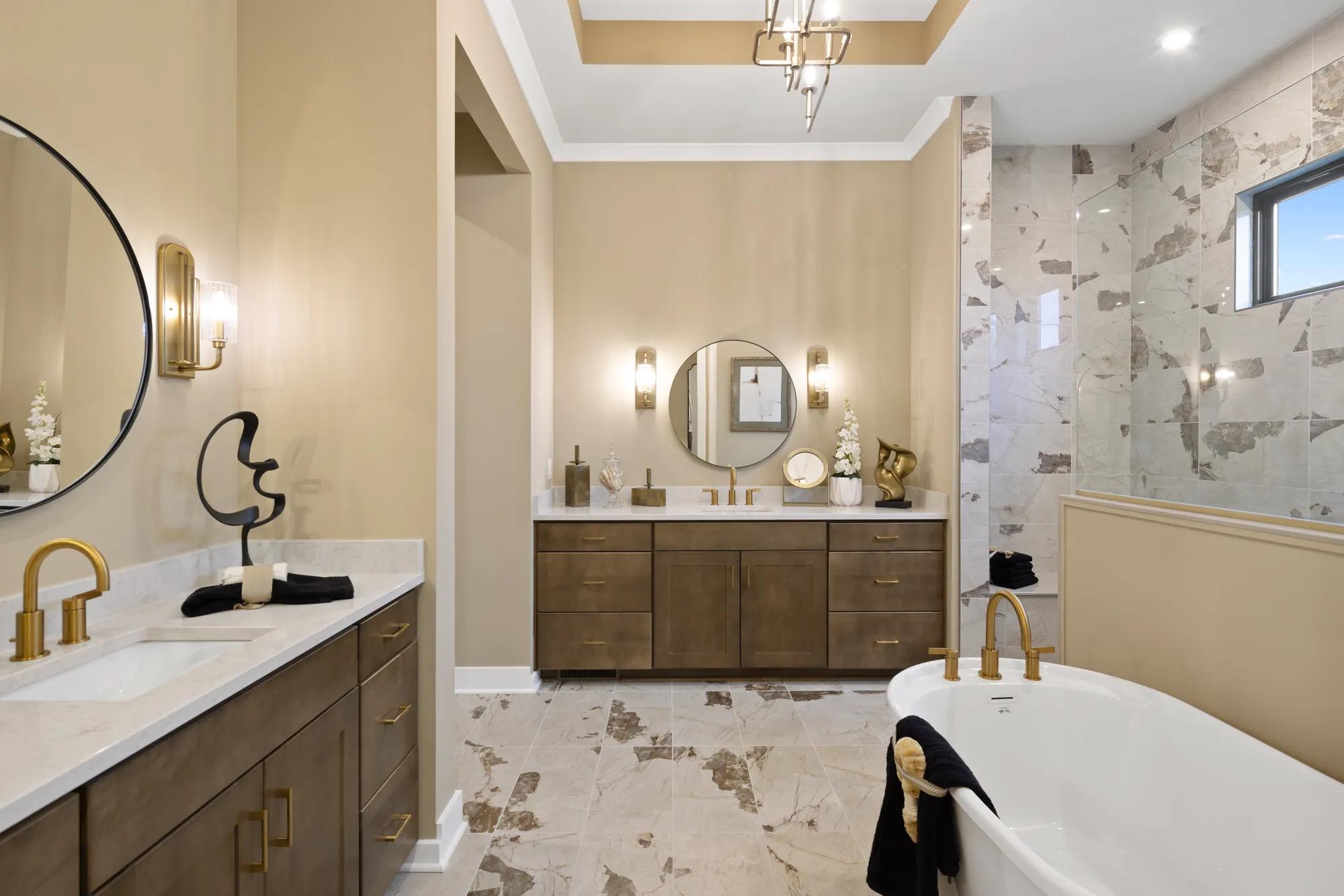 Custom home primary bathroom with double vanities and freestanding tub