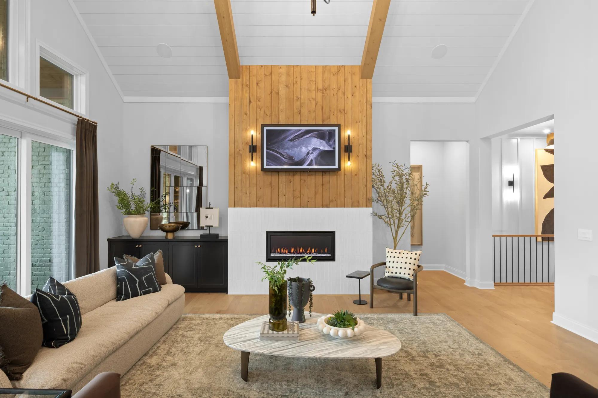 Custom home fireplace with light wood paneling 