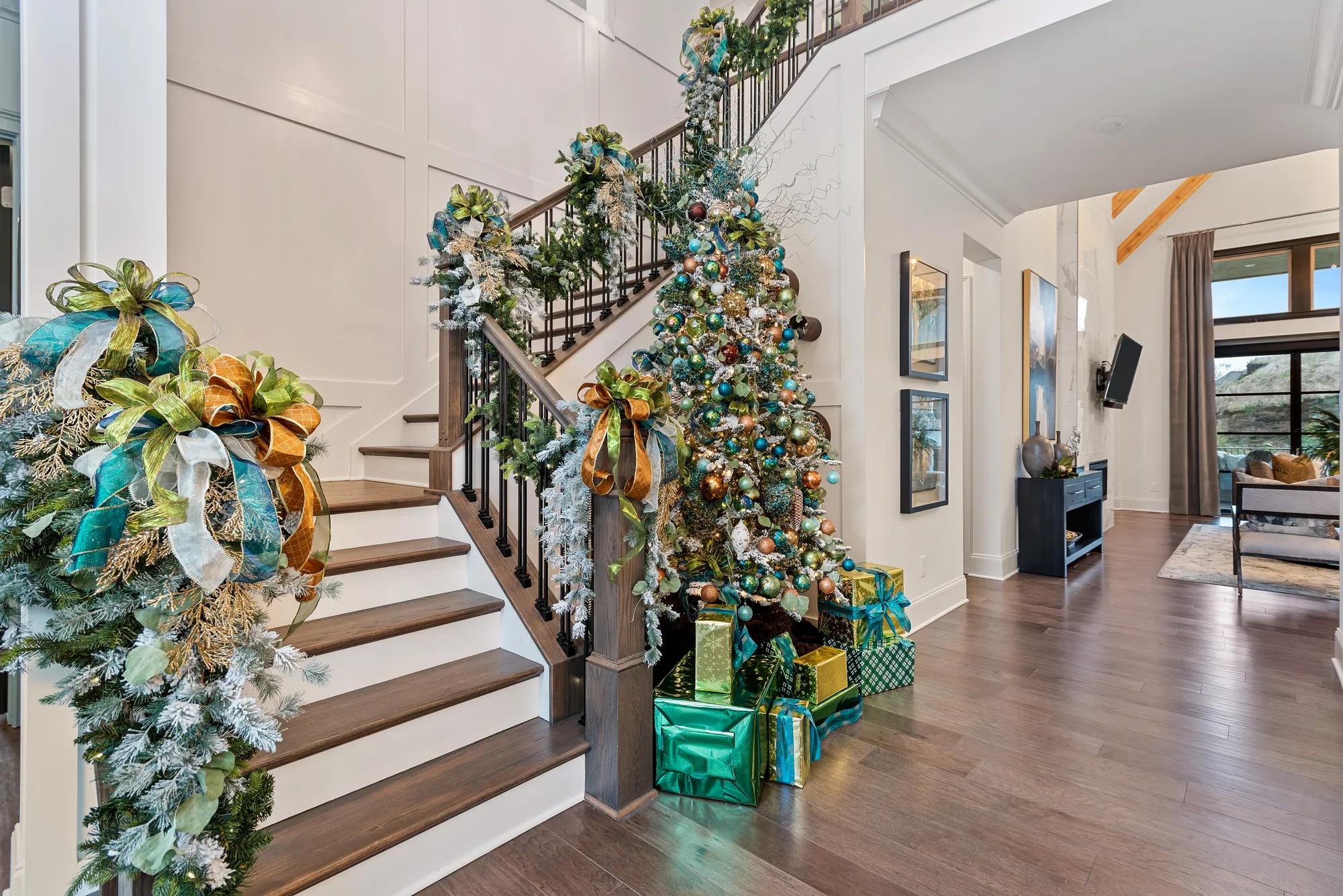 entryway with staircase decorated for the holidays