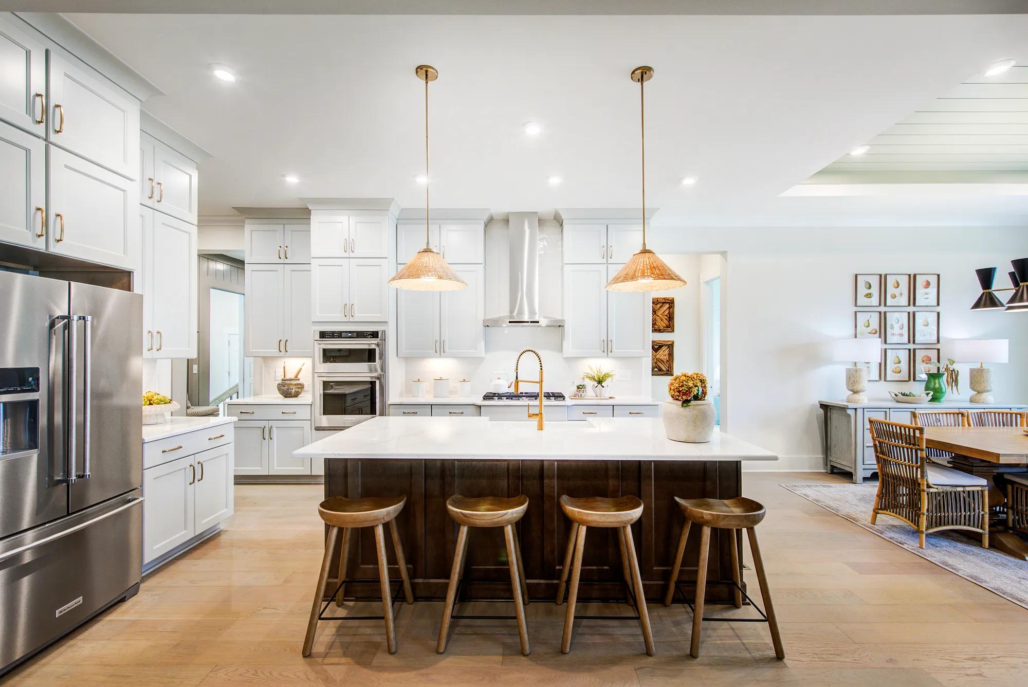 Custom home kitchen with off-white cabinets and dark wood island