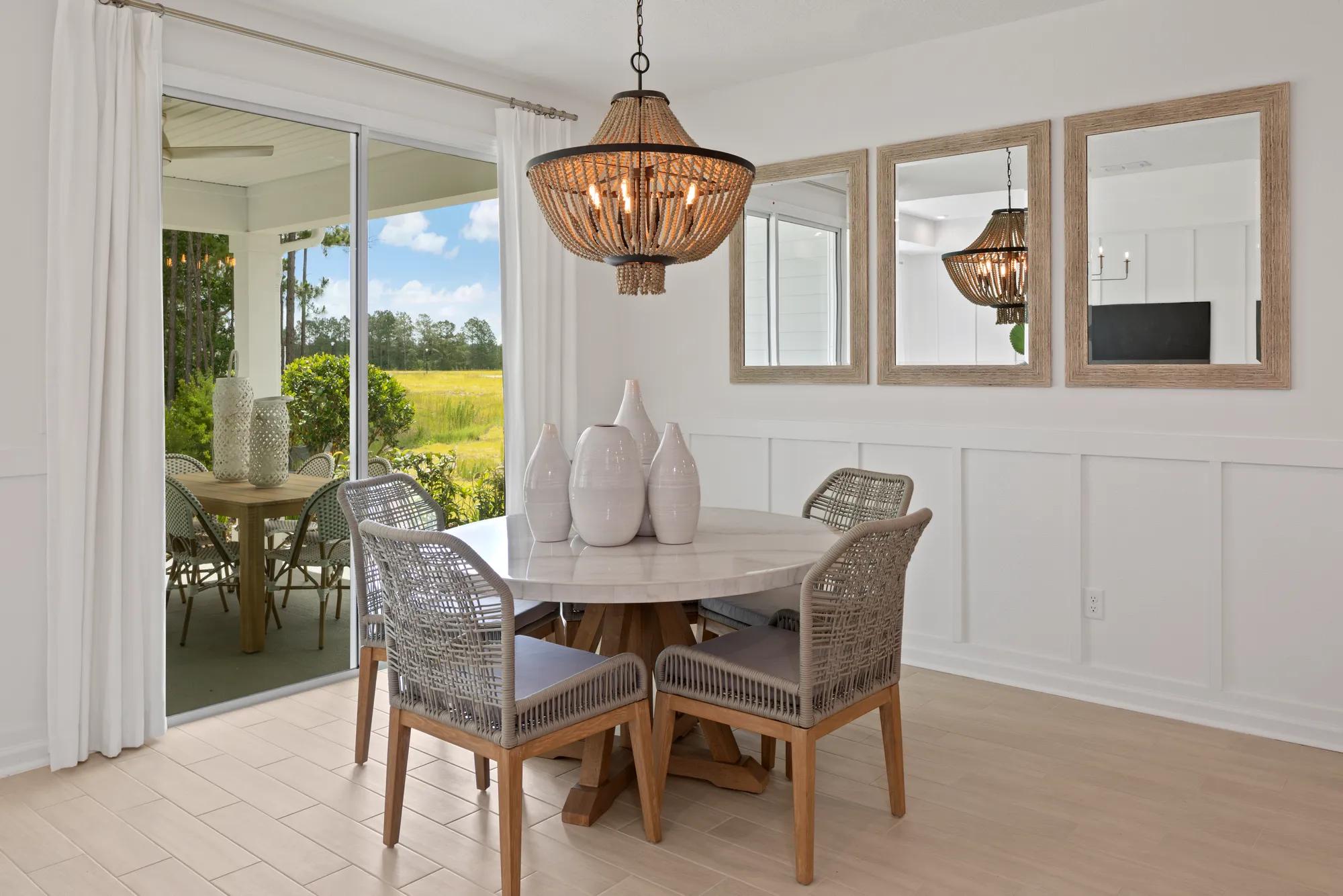 round dining table beside sliding glass door