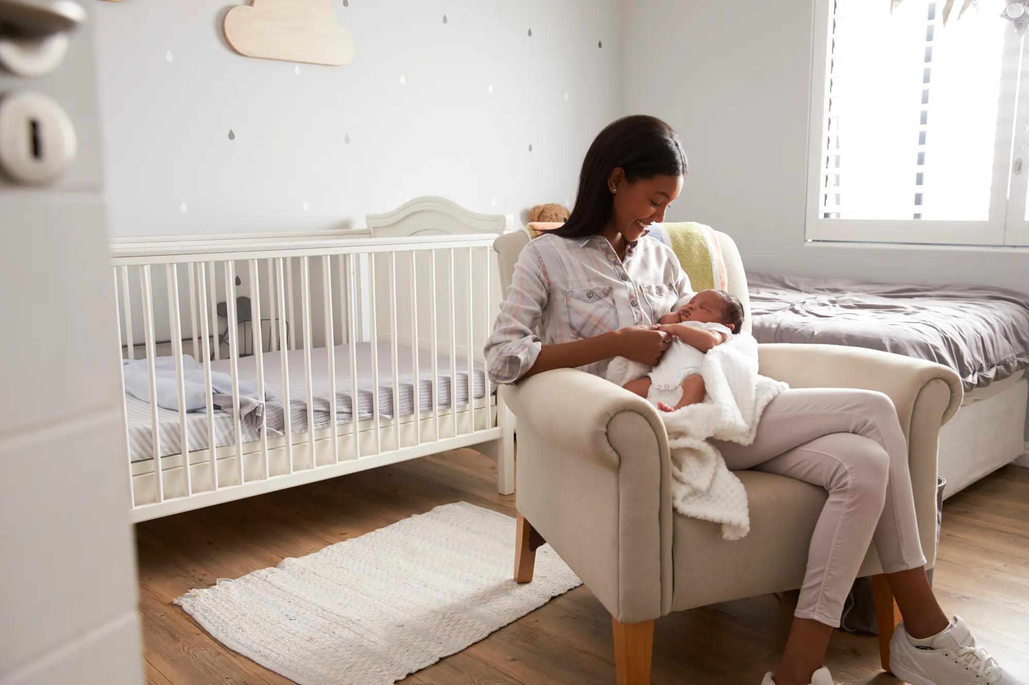 Mother and baby in new home bedroom