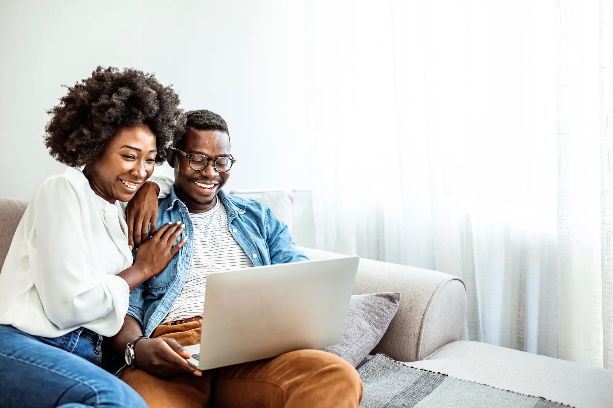 Couple using technology in their new home family room