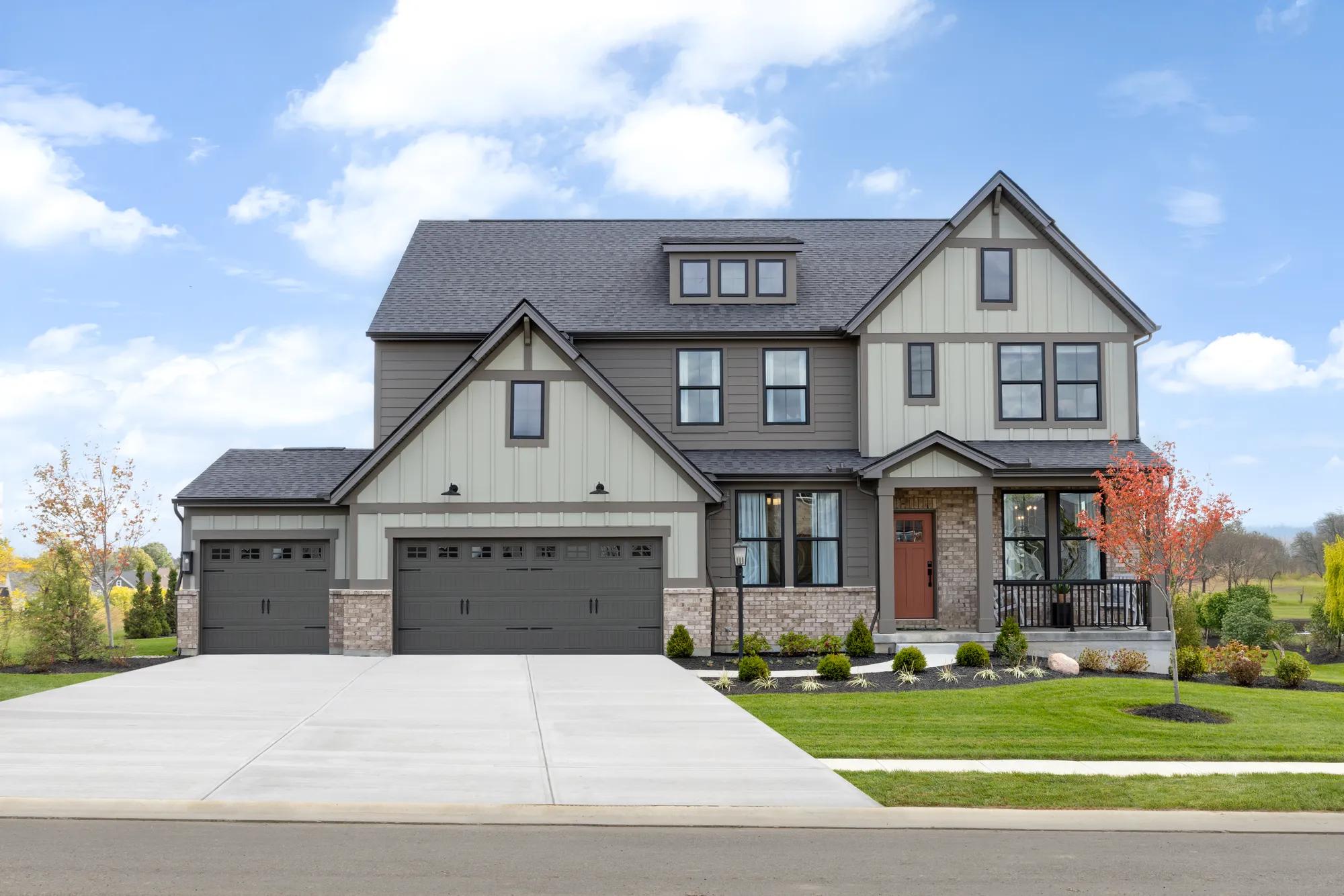 light brick
vertical siding
black windows
covered front porch