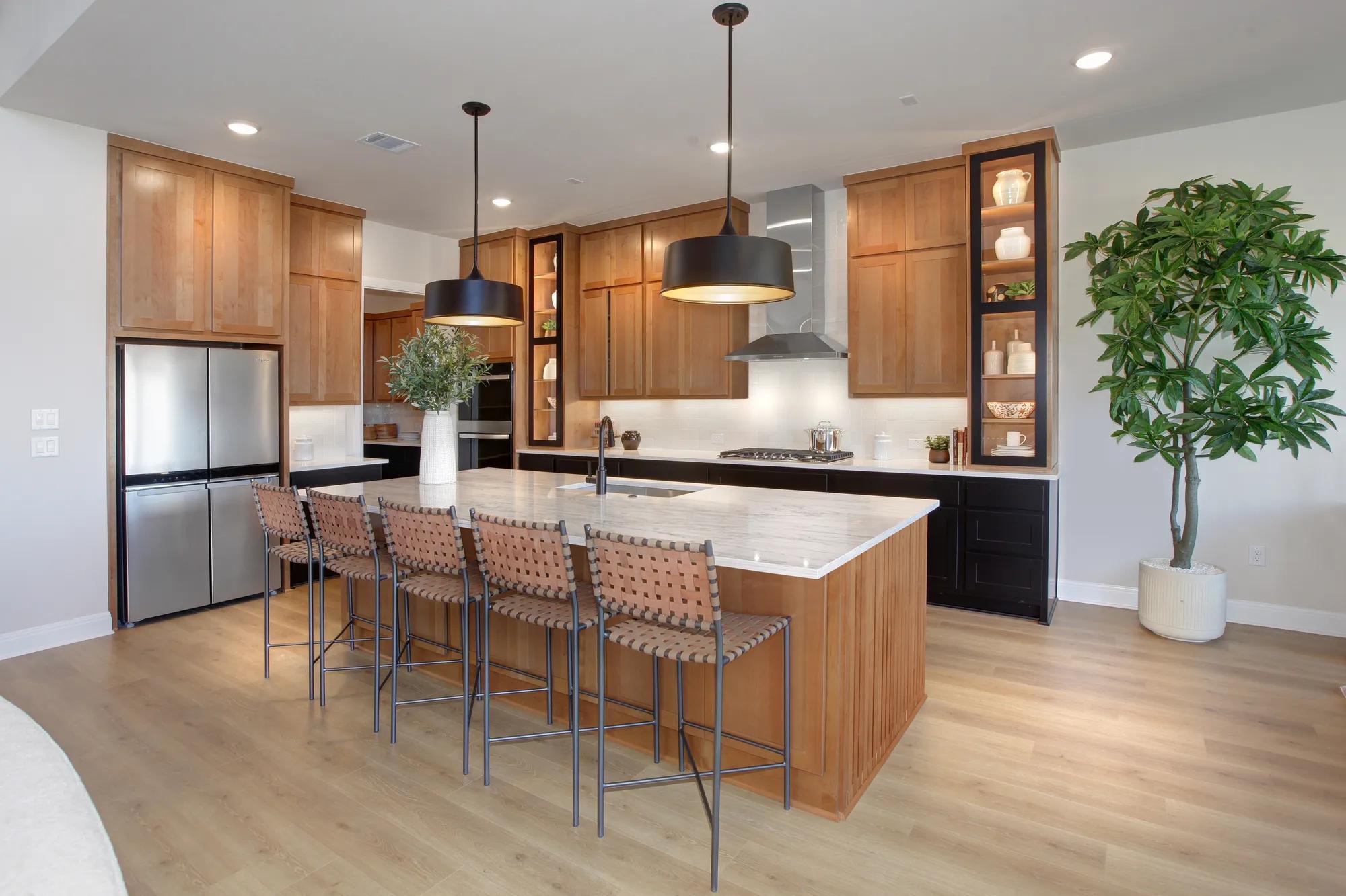 Modern kitchen with black and wood cabinets and stainless steel appliances