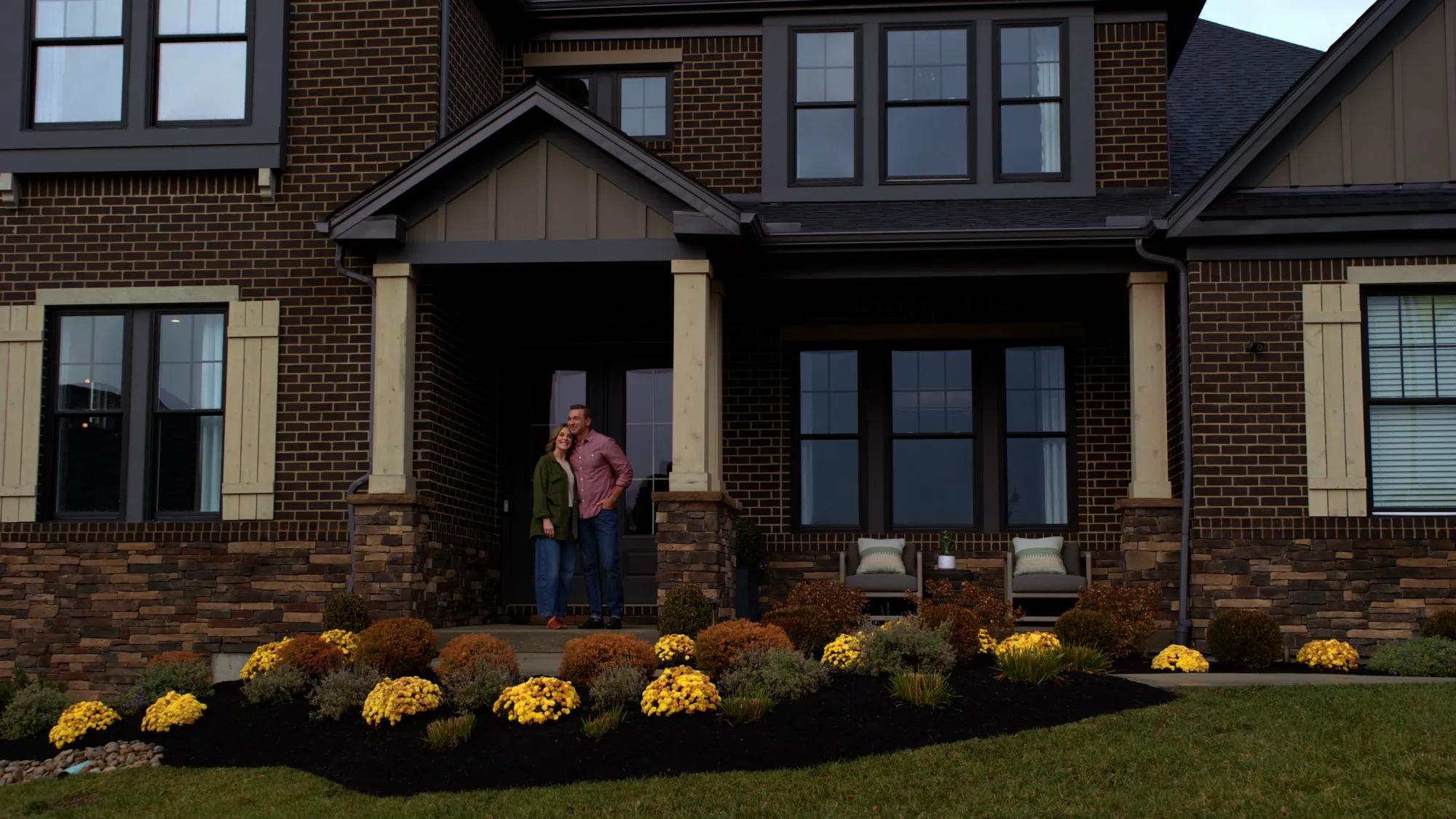 Couple on front porch of new custom home