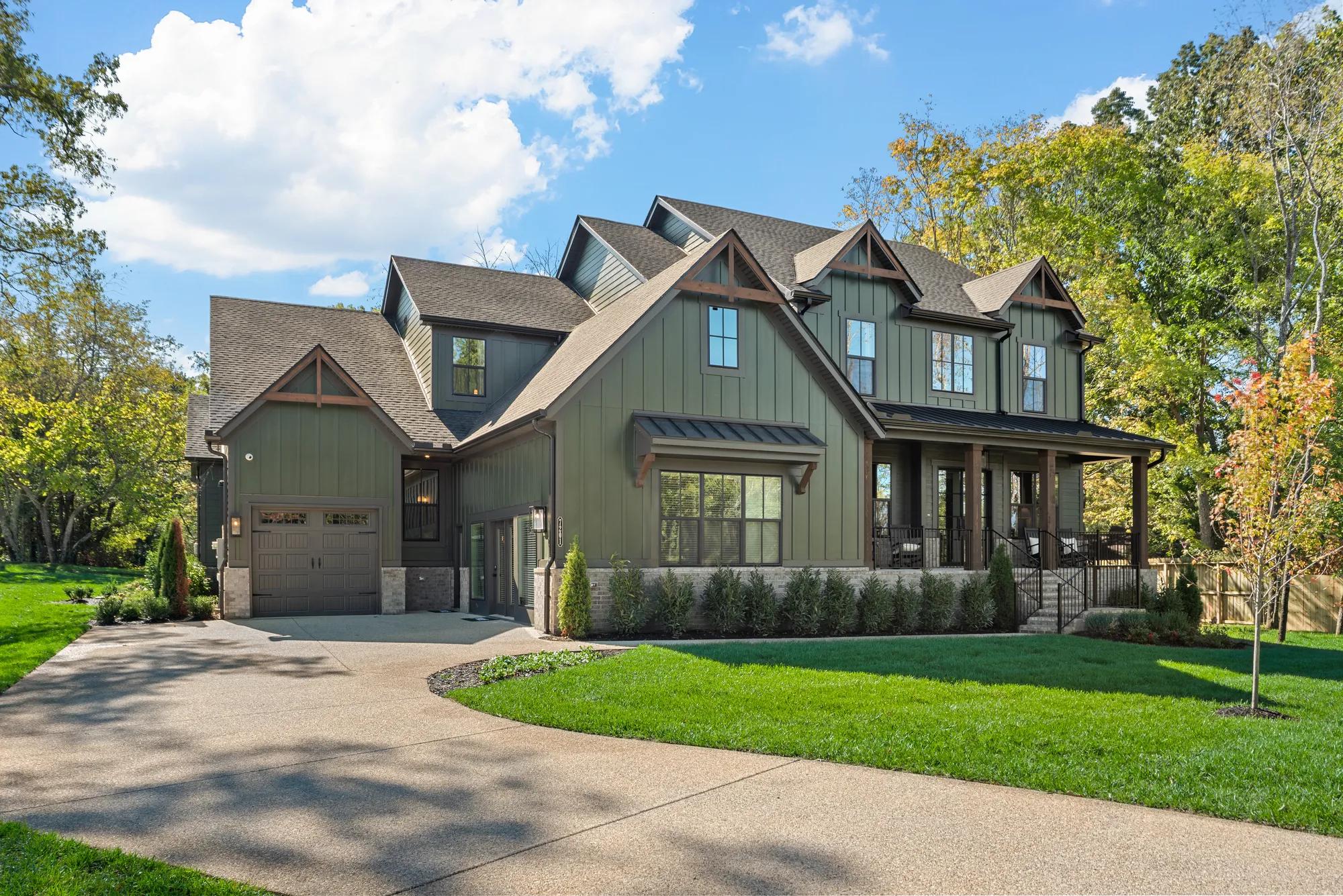 Custom home with green board and batten, cedar wood accents, and black frame windows