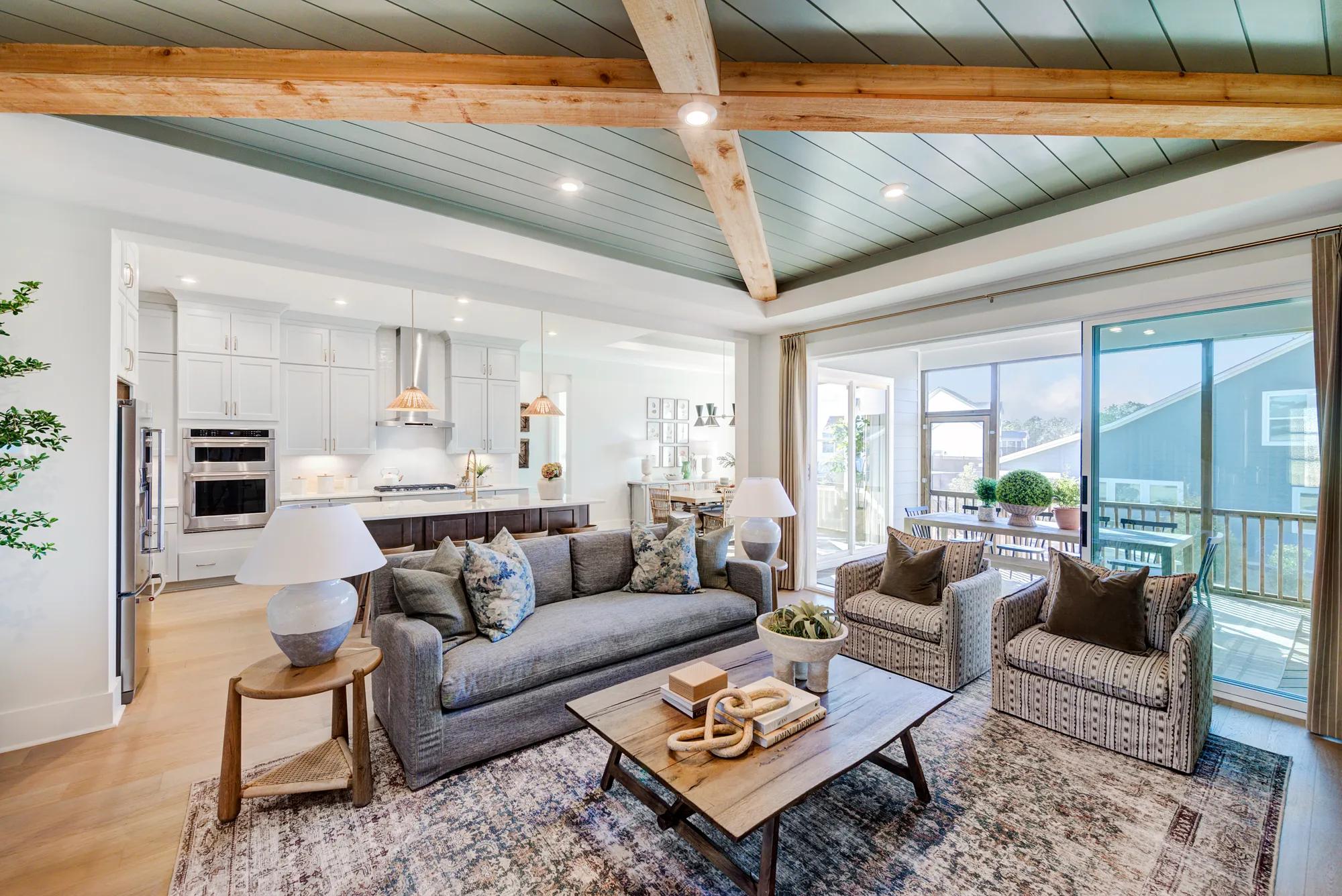 Custom home open floor plan family room, kitchen, dining, and screen porch