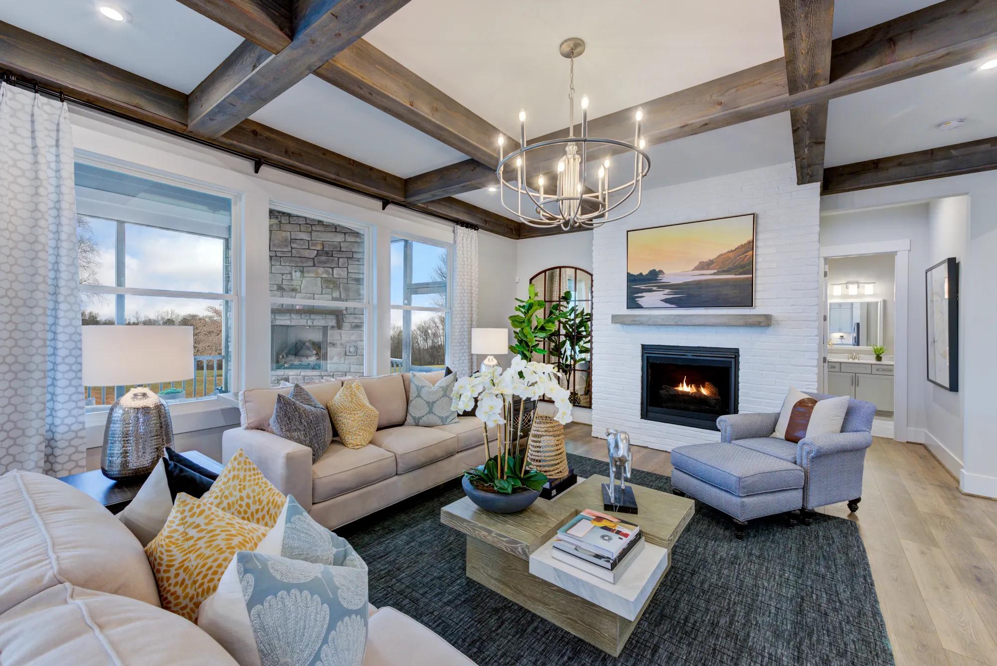 family room with beam ceiling and fireplace