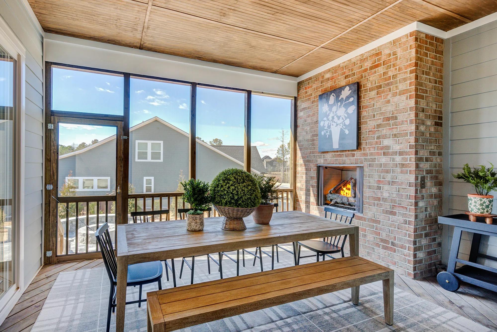 Custom home screened-in porch with brick fireplace