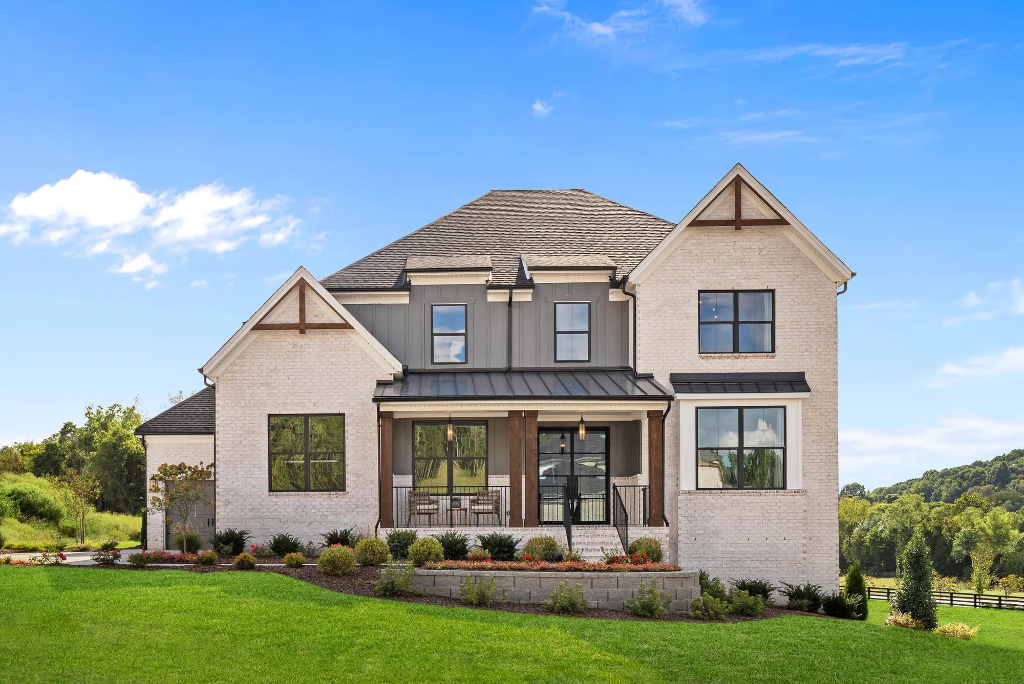 Custom home with large front porch and brick exterior