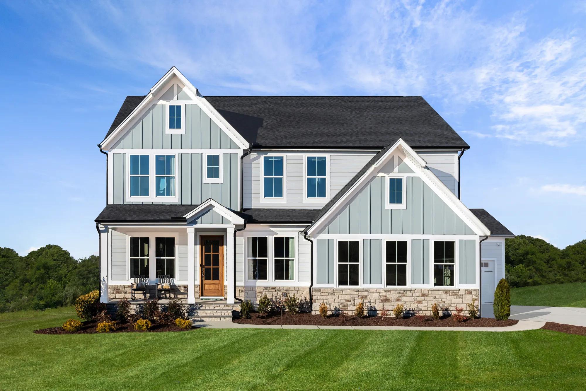 custom home with stone, siding and board and batten