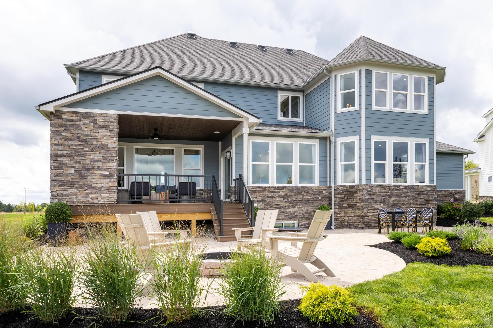 Custom home backyard outdoor living area with firepit and covered porch
