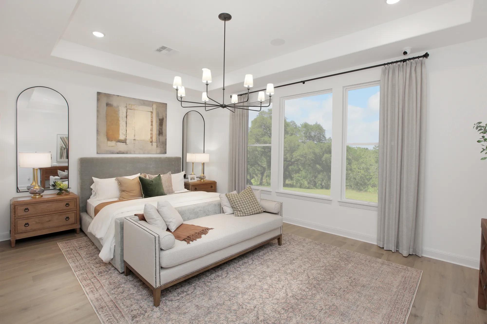 custom home primary bedroom with tray ceiling