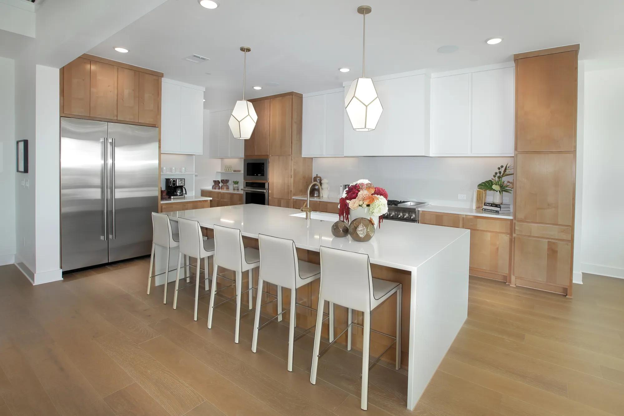 Custom home kitchen with light wood and white cabinets