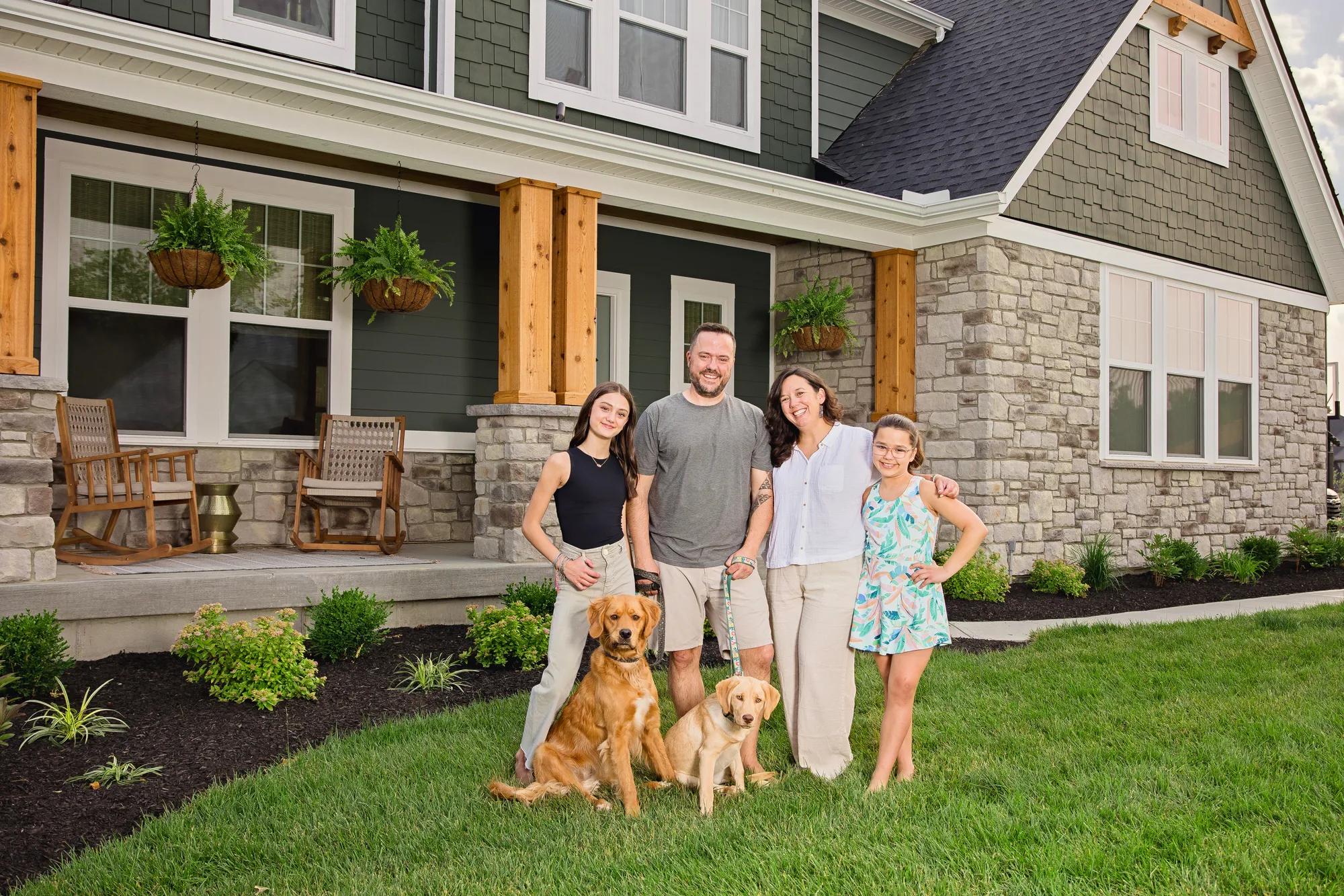 New homeowners outside of their Alden home