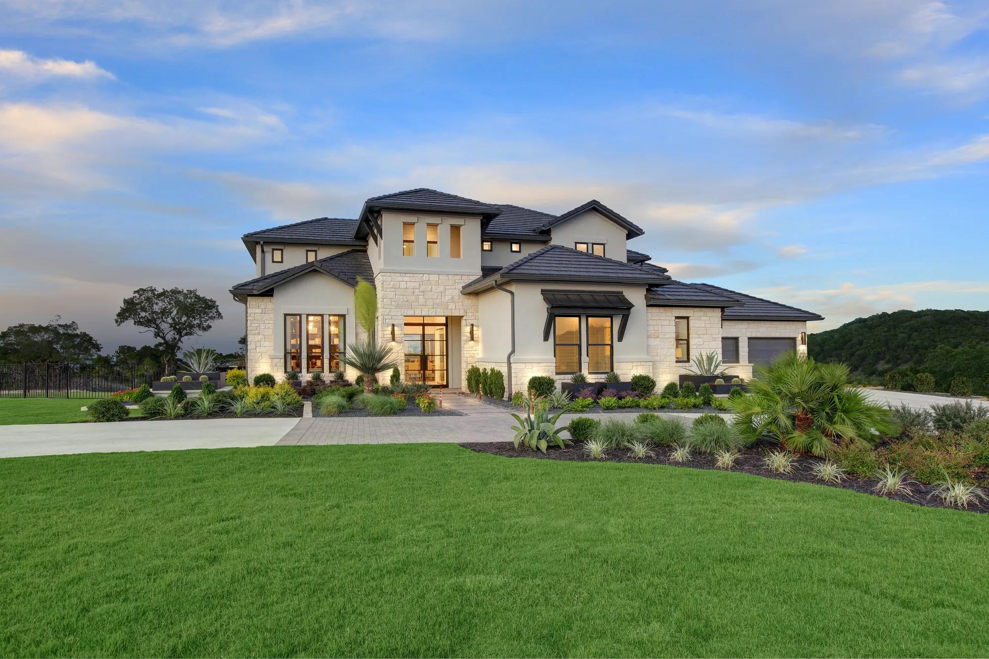 custom two-story home with stone and stucco exterior
