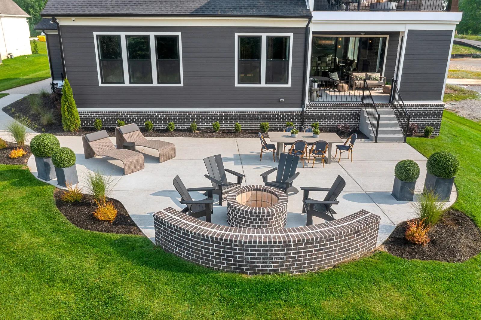 Custom home landscaped backyard with spacious open patio with firepit