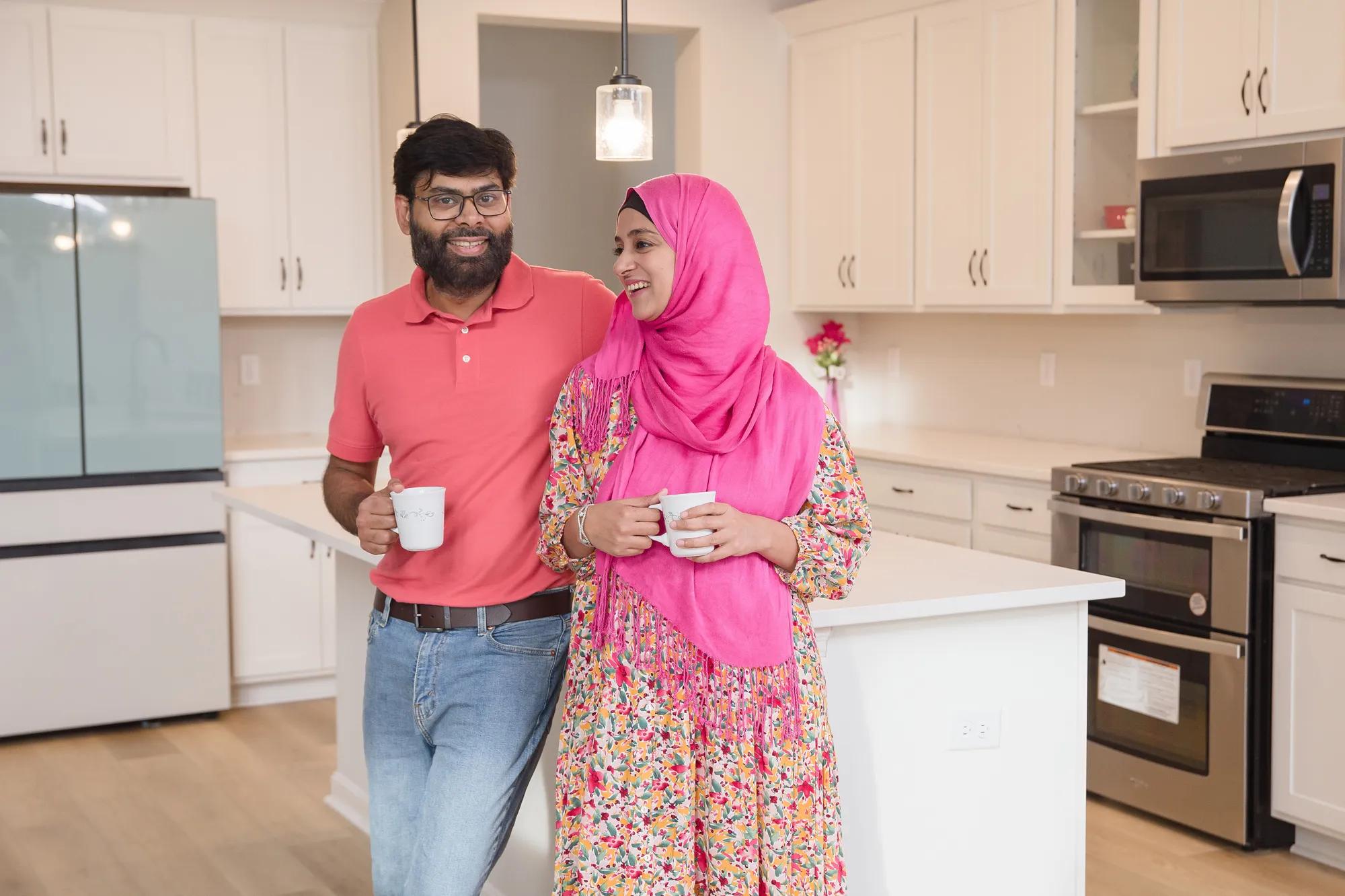 New homeowners standing around in the Alwick kitchen