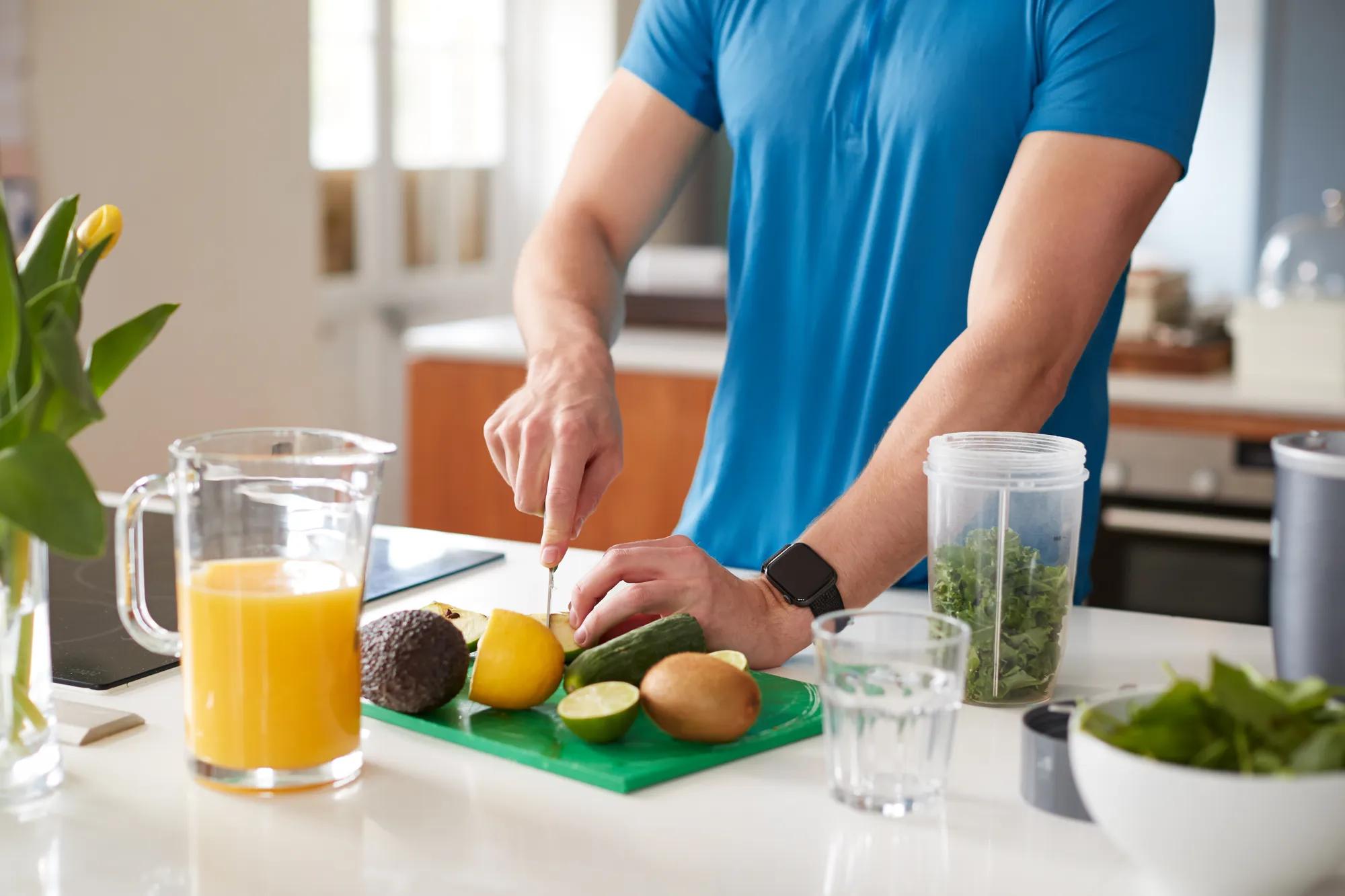 Man chopping fruit in new home kitchen