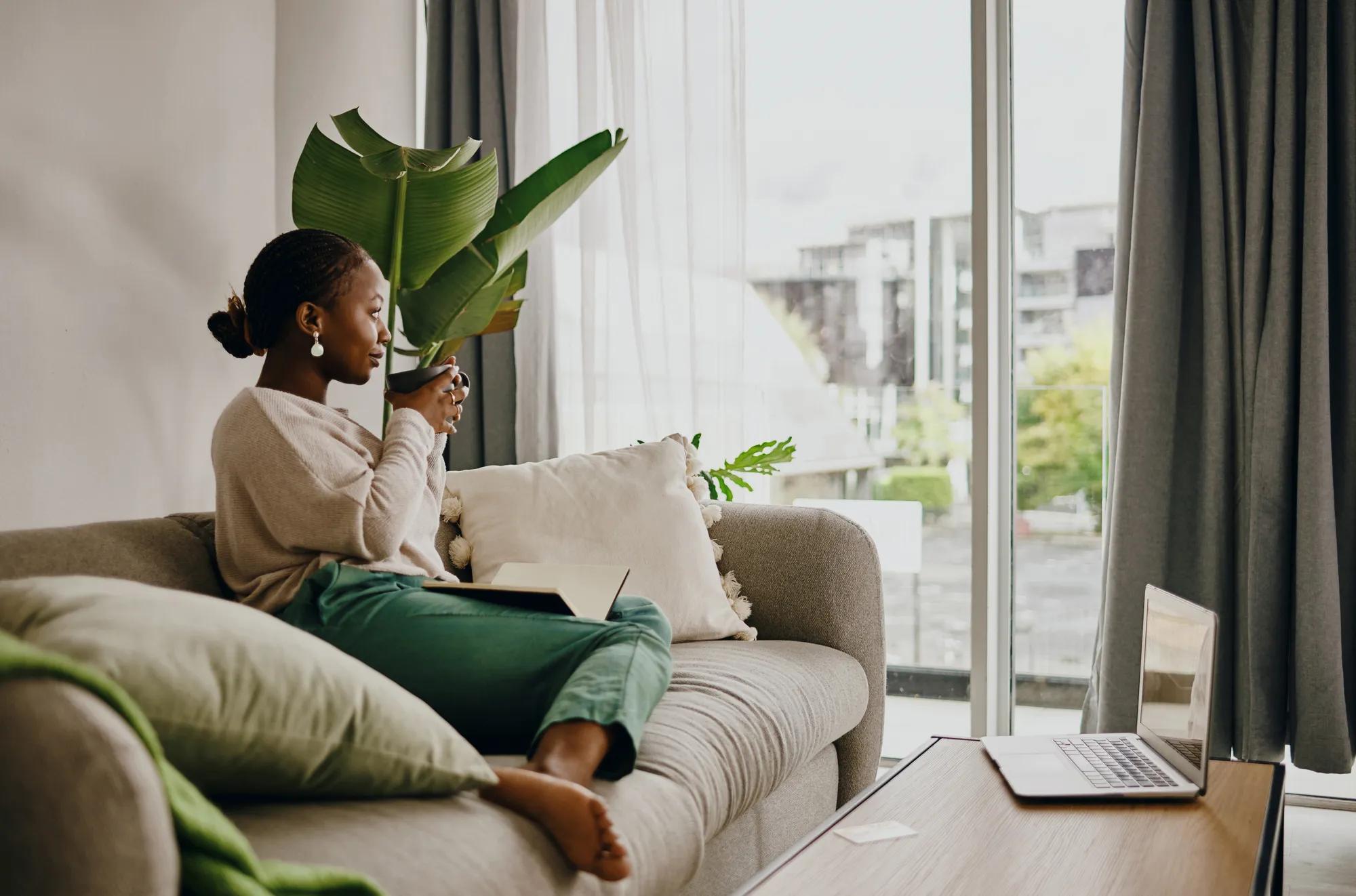 Woman relaxing in new home living room