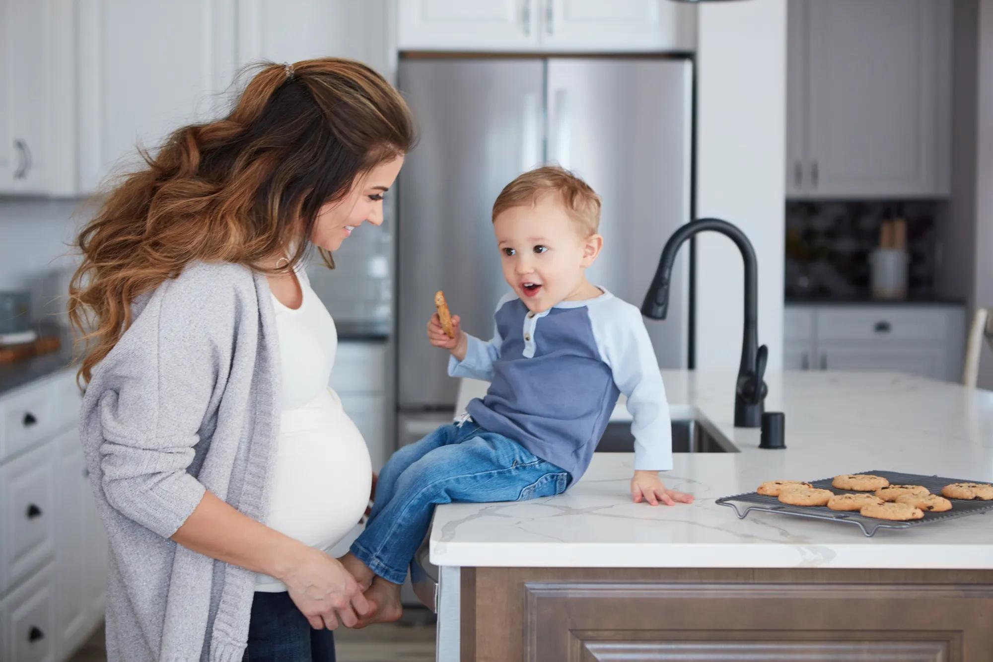 Mother and son baking cookies at home